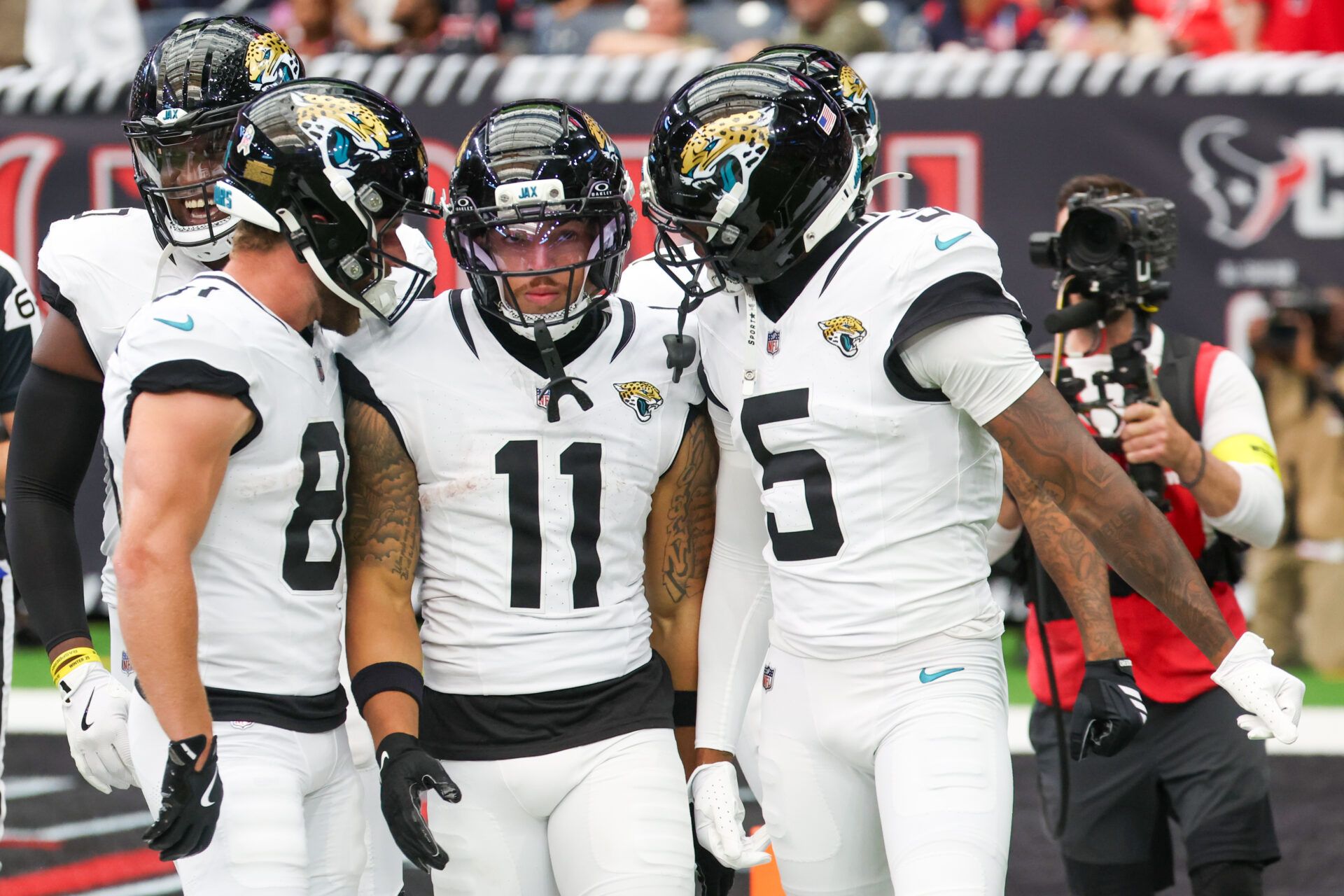 Jacksonville Jaguars wide receiver Austin Trammell (81) and wide receiver Dyami Brown (5) react with wide receiver Parker Washington (11) after a 72-yard punt return for a touchdown against the Houston Texans during the first half at NRG Stadium.