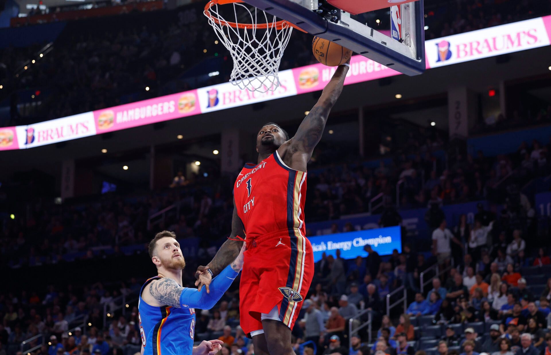 New Orleans Pelicans forward Zion Williamson (1) goes up for a dunk beside Oklahoma City Thunder center Isaiah Hartenstein (55) during the second half at Paycom Center.