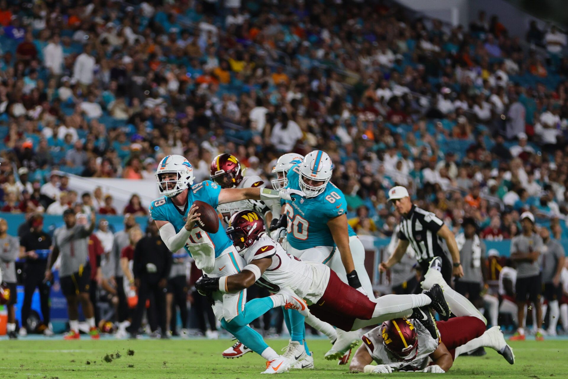 Miami Dolphins quarterback Skylar Thompson (19) runs with the football against Washington Commanders during the third quarter of a preseason game at Hard Rock Stadium.