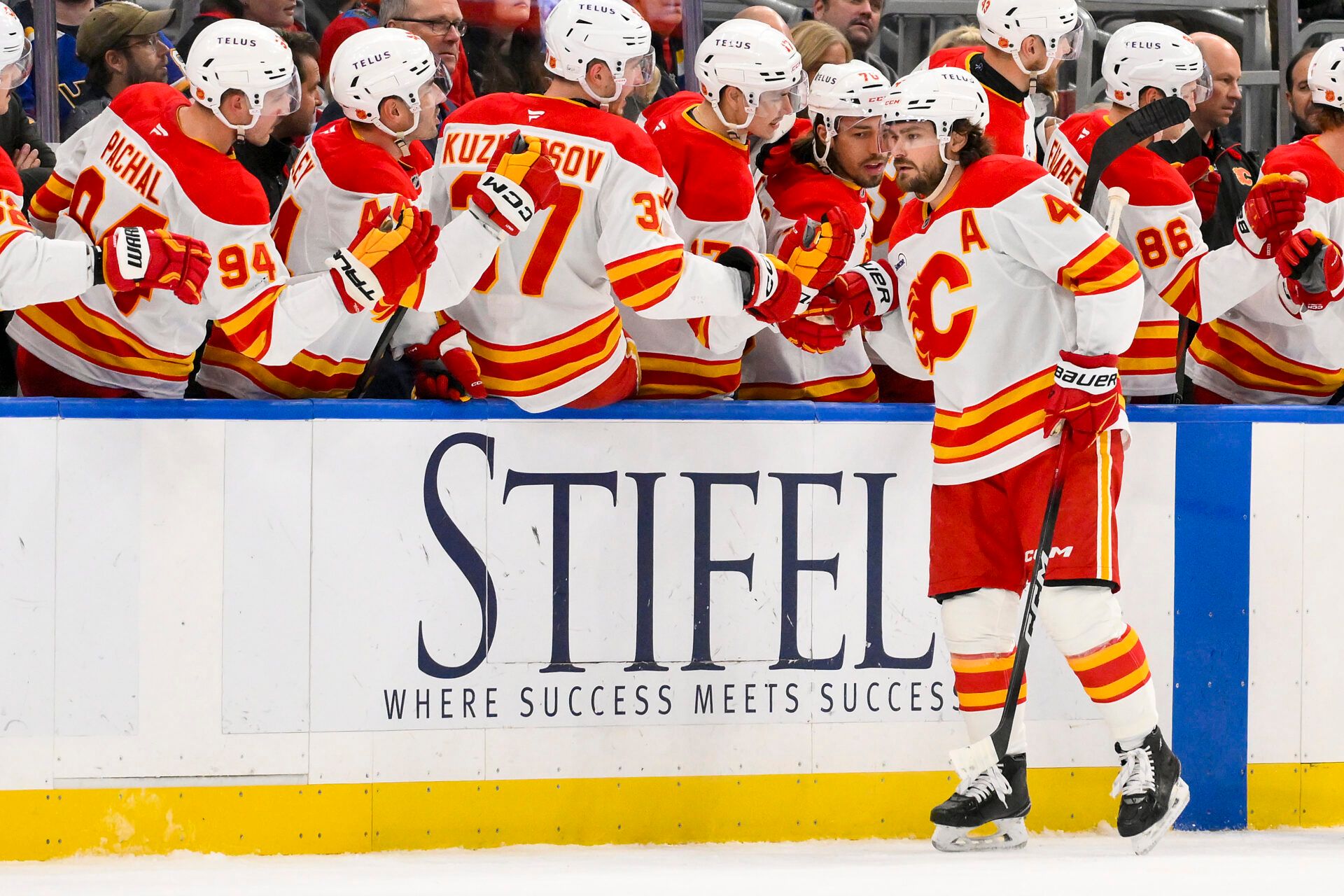 Calgary Flames defenseman Rasmus Andersson (4) is congratulated by teammates after scoring against the St. Louis Blues during the second period at Enterprise Center.