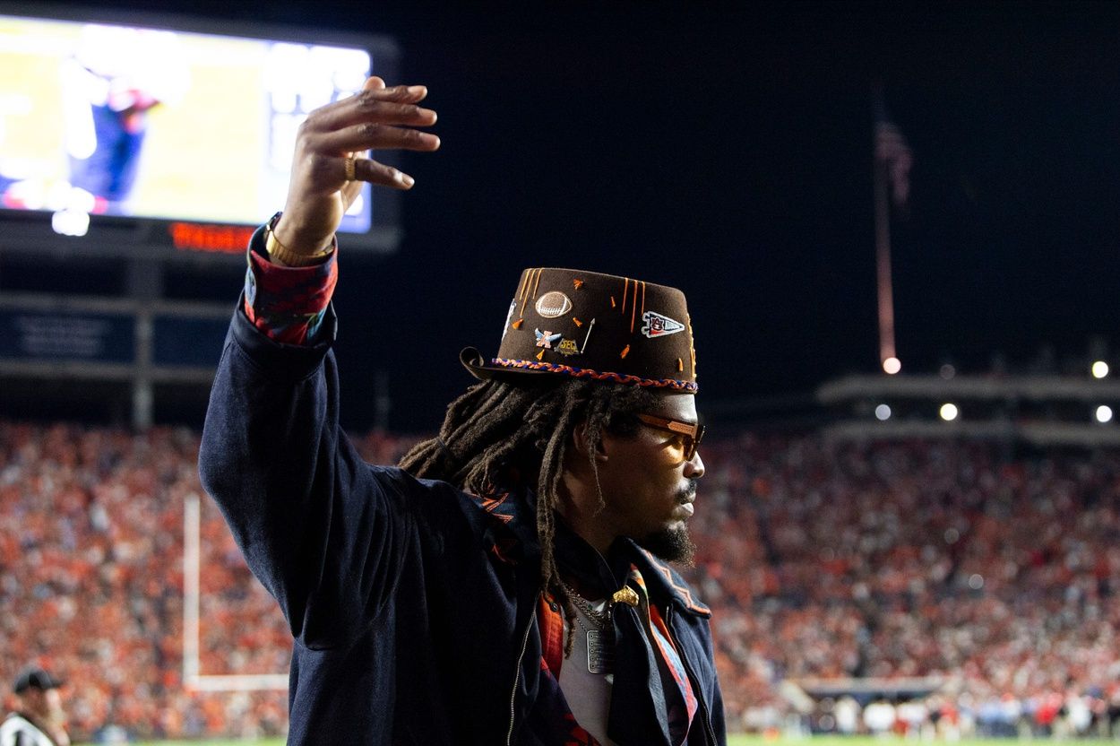 Former Auburn quarterback Cam Newton cheers on his team from the sideline as Auburn Tigers take on Georgia Bulldogs at Jordan-Hare Stadium in Auburn, Ala. on Saturday, Oct. 11, 2025. Auburn Tigers lead Georgia Bulldogs 10-3 at halftime.
