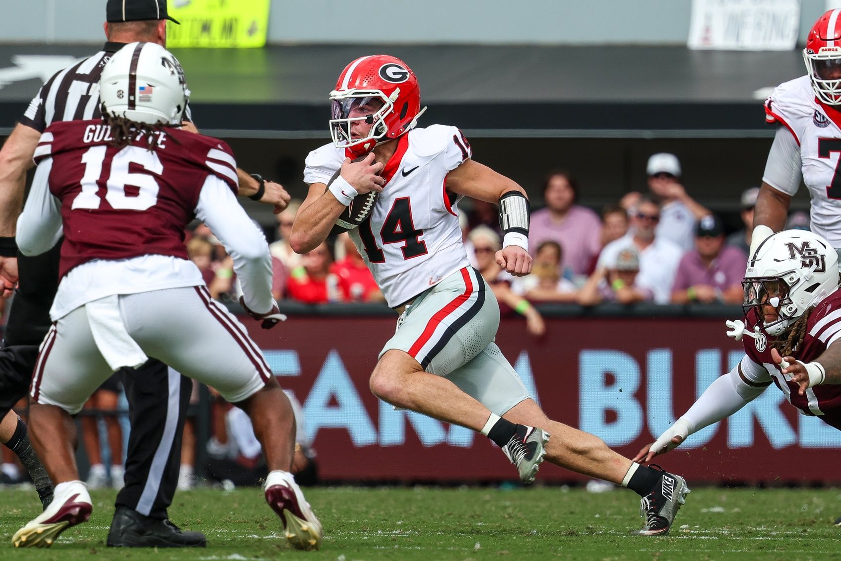 Georgia Bulldogs quarterback  Gunner Stockton (14) runs with the ball against the Mississippi State Bulldogs during the first half at Davis Wade Stadium at Scott Field.
