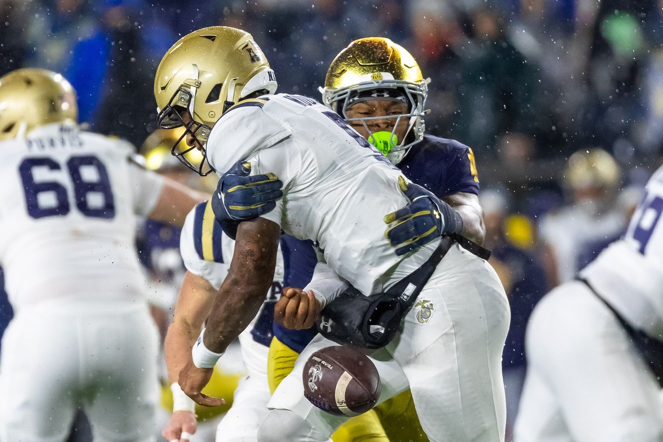 Notre Dame Fighting Irish linebacker Jaiden Ausberry (4) forces Navy Midshipmen quarterback Braxton Woodson (5) to fumble during the second half at Notre Dame Stadium.