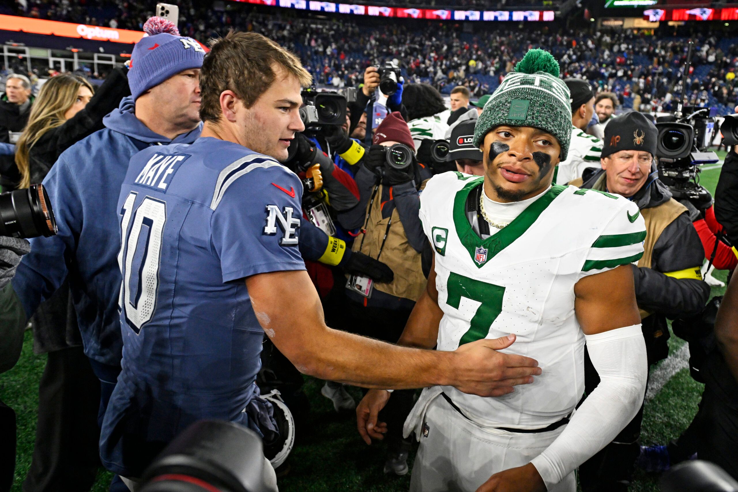 New England Patriots quarterback Drake Maye (10) and New York Jets quarterback Justin Fields (7) react after the game at Gillette Stadium.