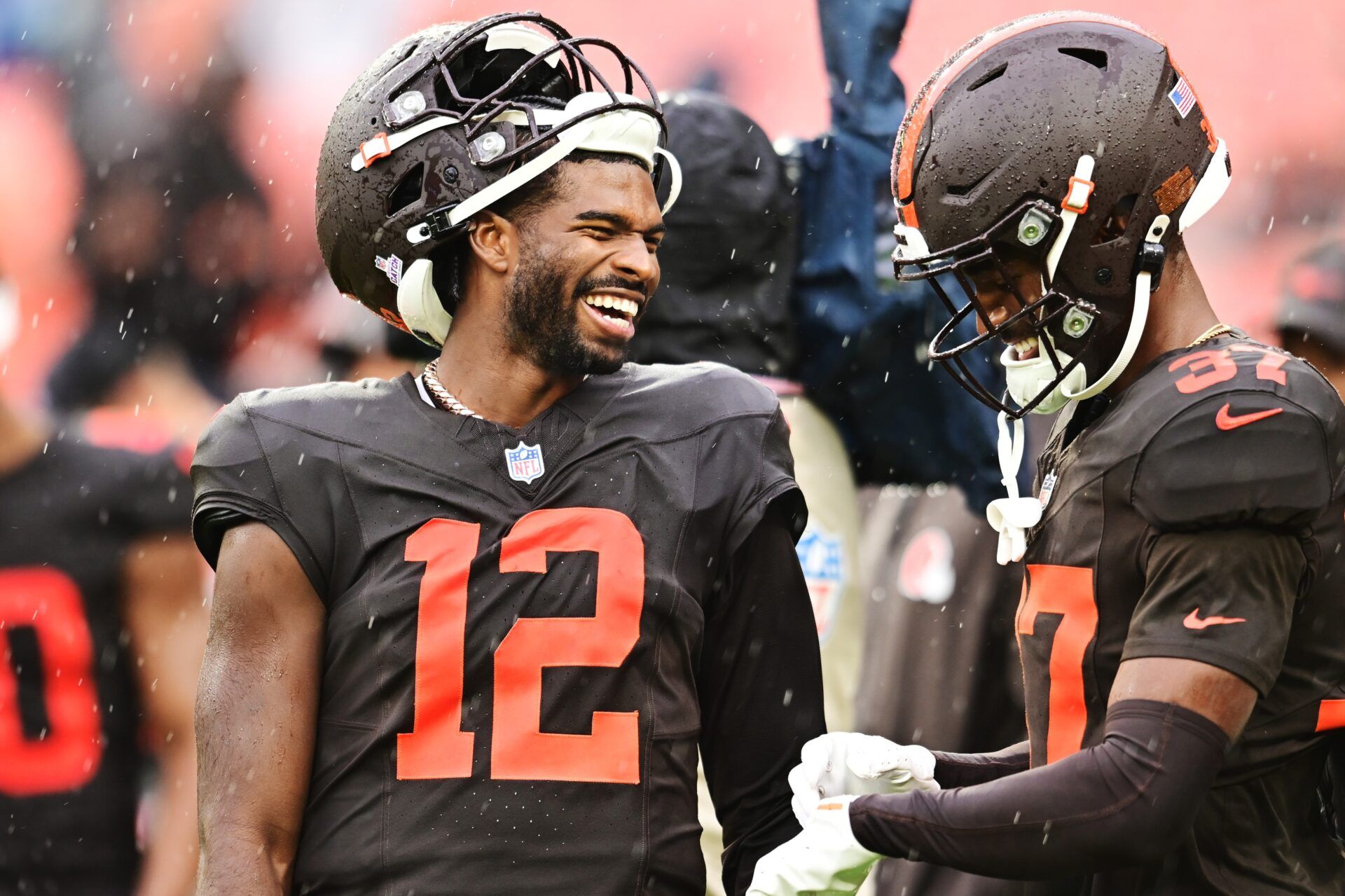 Cleveland Browns quarterback Shedeur Sanders (12) and cornerback Dom Jones (37) laugh before the game between the Browns and the Miami Dolphins at Huntington Bank Field.