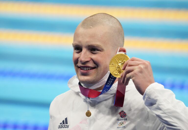 Adam Peaty (GBR) with his gold medal during the medals ceremony for the men's 100m breaststroke during the Tokyo 2020 Olympic Summer Games at Tokyo Aquatics Centre.