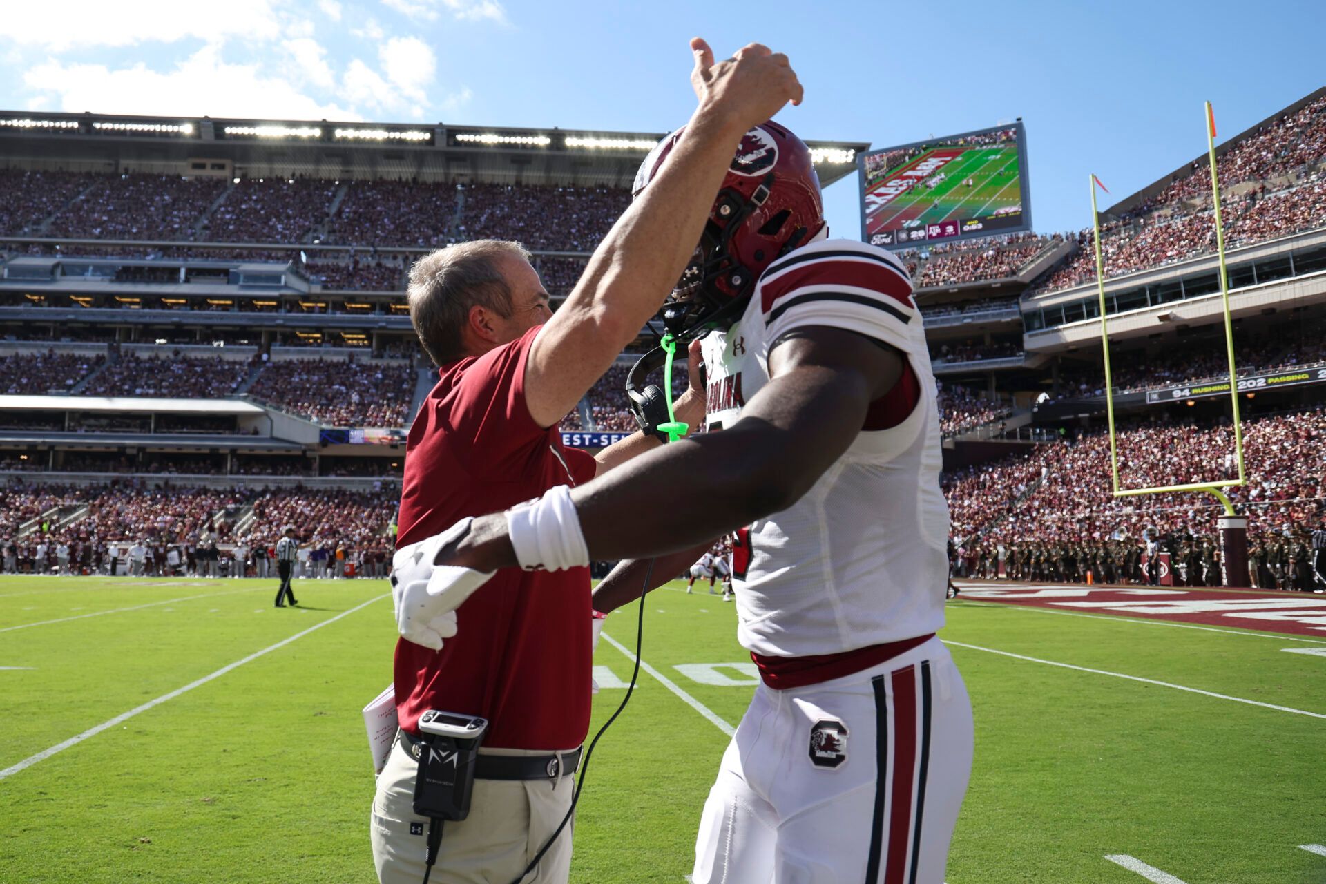 South Carolina Gamecocks wide receiver Nyck Harbor (8) is embraced by head coach Shane Beamer after scoring a touchdown during the second quarter against the Texas A&M Aggies at Kyle Field.