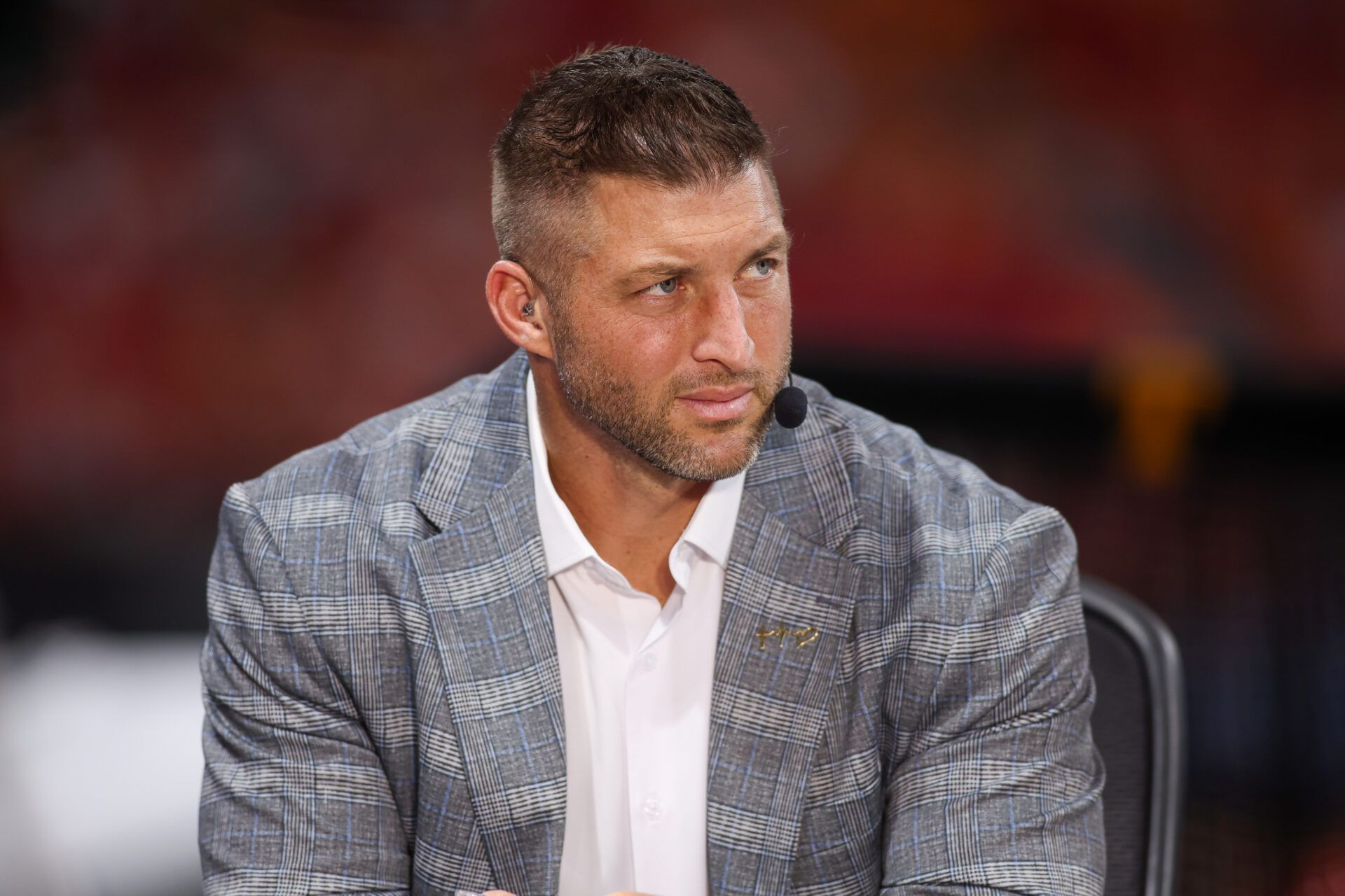 SEC Network analyst Tim Tebow on the field before a game between the Tennessee Volunteers and Syracuse Orange at Mercedes-Benz Stadium.