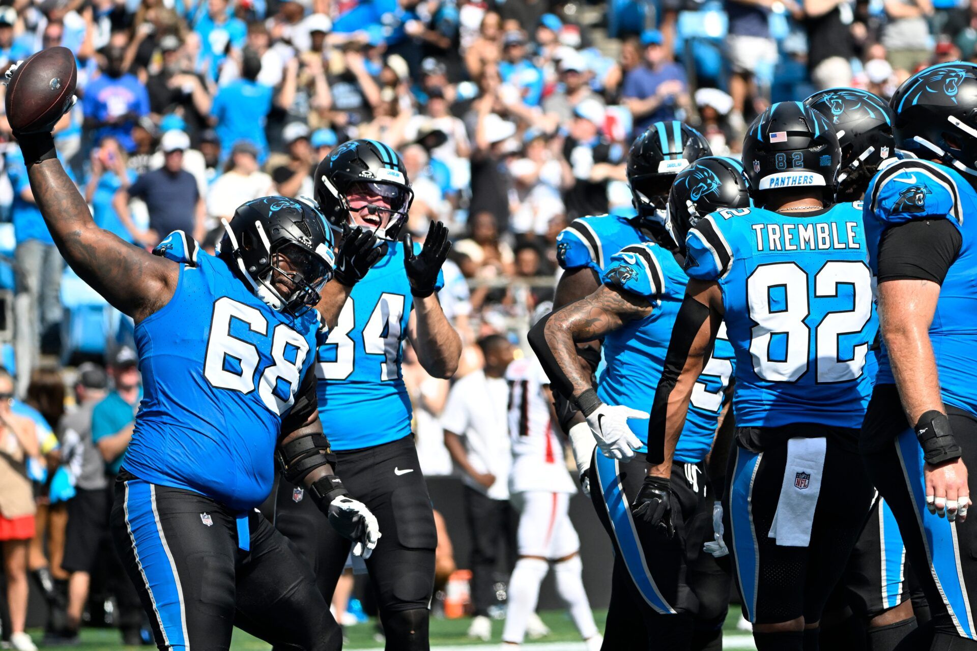 Carolina Panthers guard Damien Lewis (68) spikes the ball after running back Rico Dowdle (5) scores a touchdown in the fourth quarter at Bank of America Stadium.