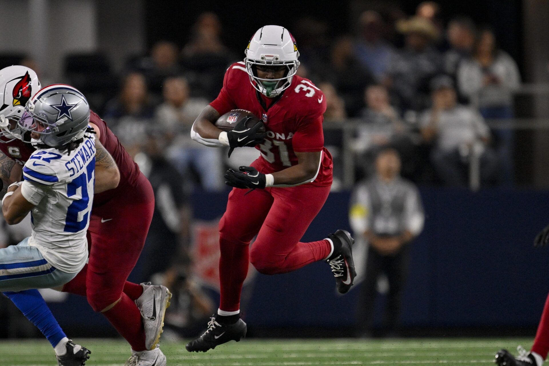 Arizona Cardinals running back Emari Demercado (31) runs with the ball during the game between the Dallas Cowboys and the Arizona Cardinals at AT&T Stadium.