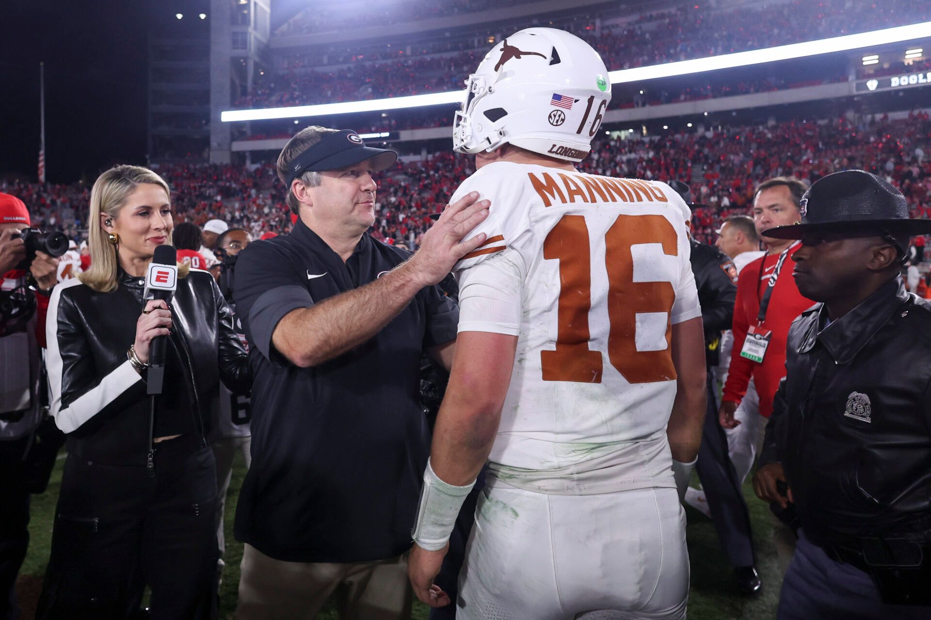 Georgia Bulldogs head coach Kirby Smart and Texas Longhorns quarterback Arch Manning (16) interact after a game at Sanford Stadium.