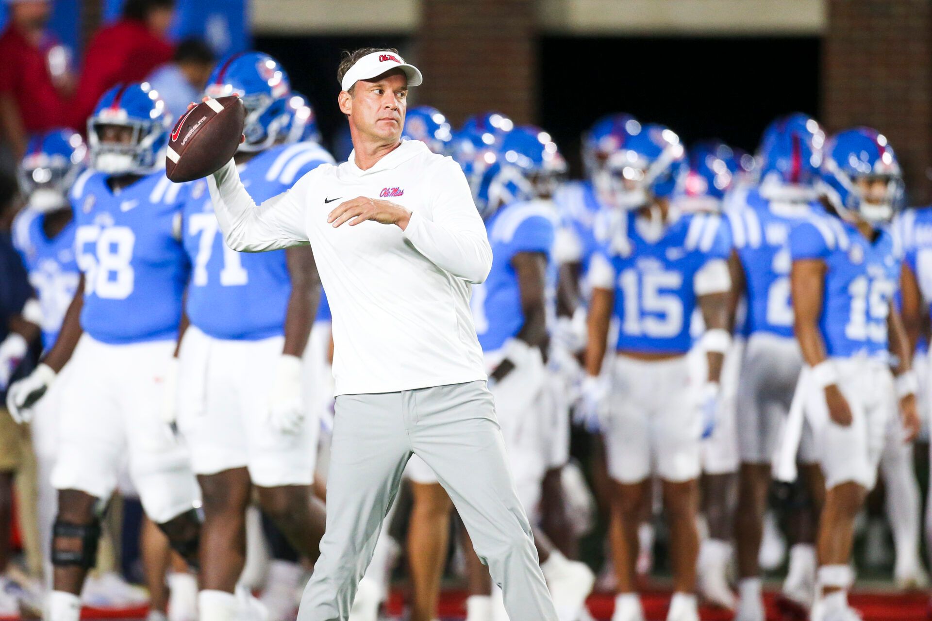 Mississippi Rebels head coach Lane Kiffin throws a football during pregame warmups against the Florida Gators at Vaught-Hemingway Stadium.