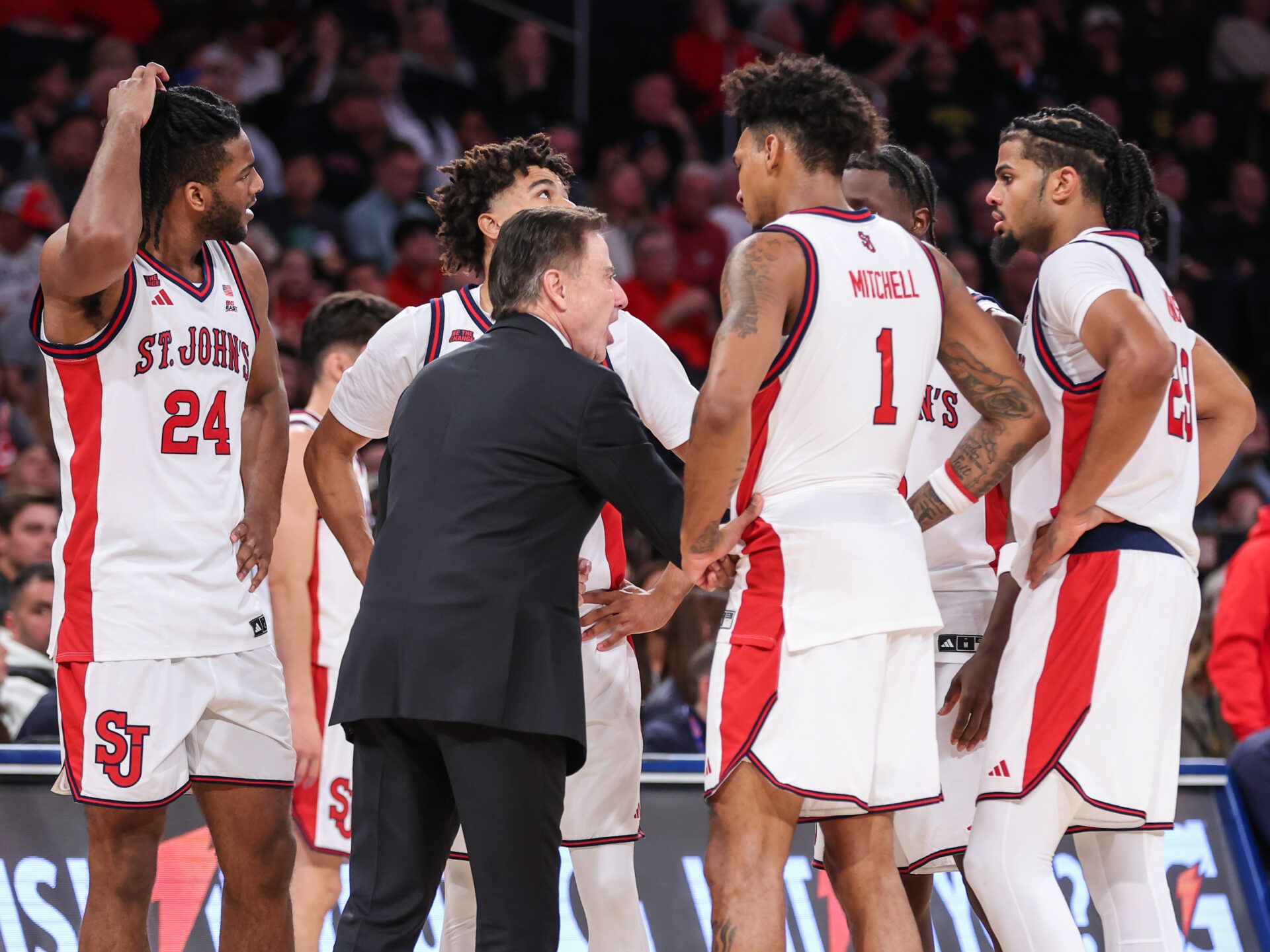 St. John's Red Storm head coach Rick Pitino talks to the team during a timeout in the second half against the Michigan Wolverines at Madison Square Garden.