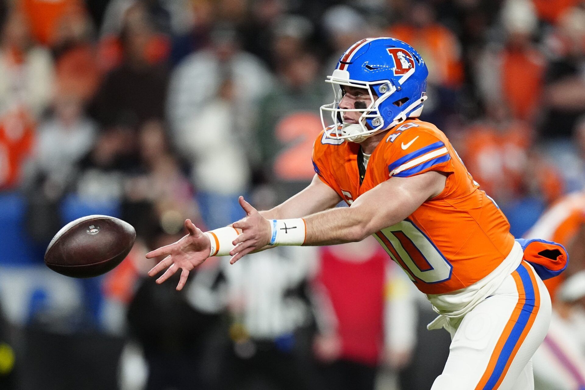Denver Broncos quarterback Bo Nix (10) pitches the ball against the Las Vegas Raiders during the first half at Empower Field at Mile High.