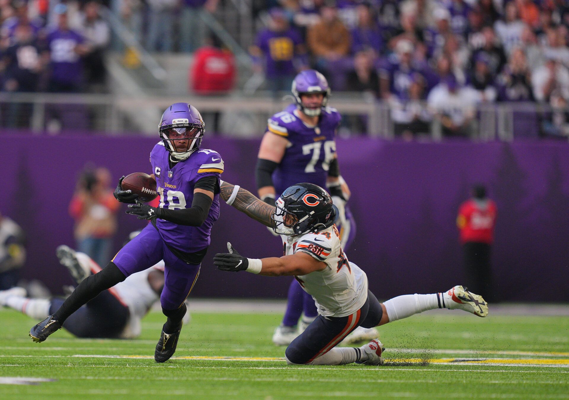 Minnesota Vikings wide receiver Justin Jefferson (18) runs for a gain past Chicago Bears linebacker Noah Sewell (44) during the fourth quarter at U.S. Bank Stadium.