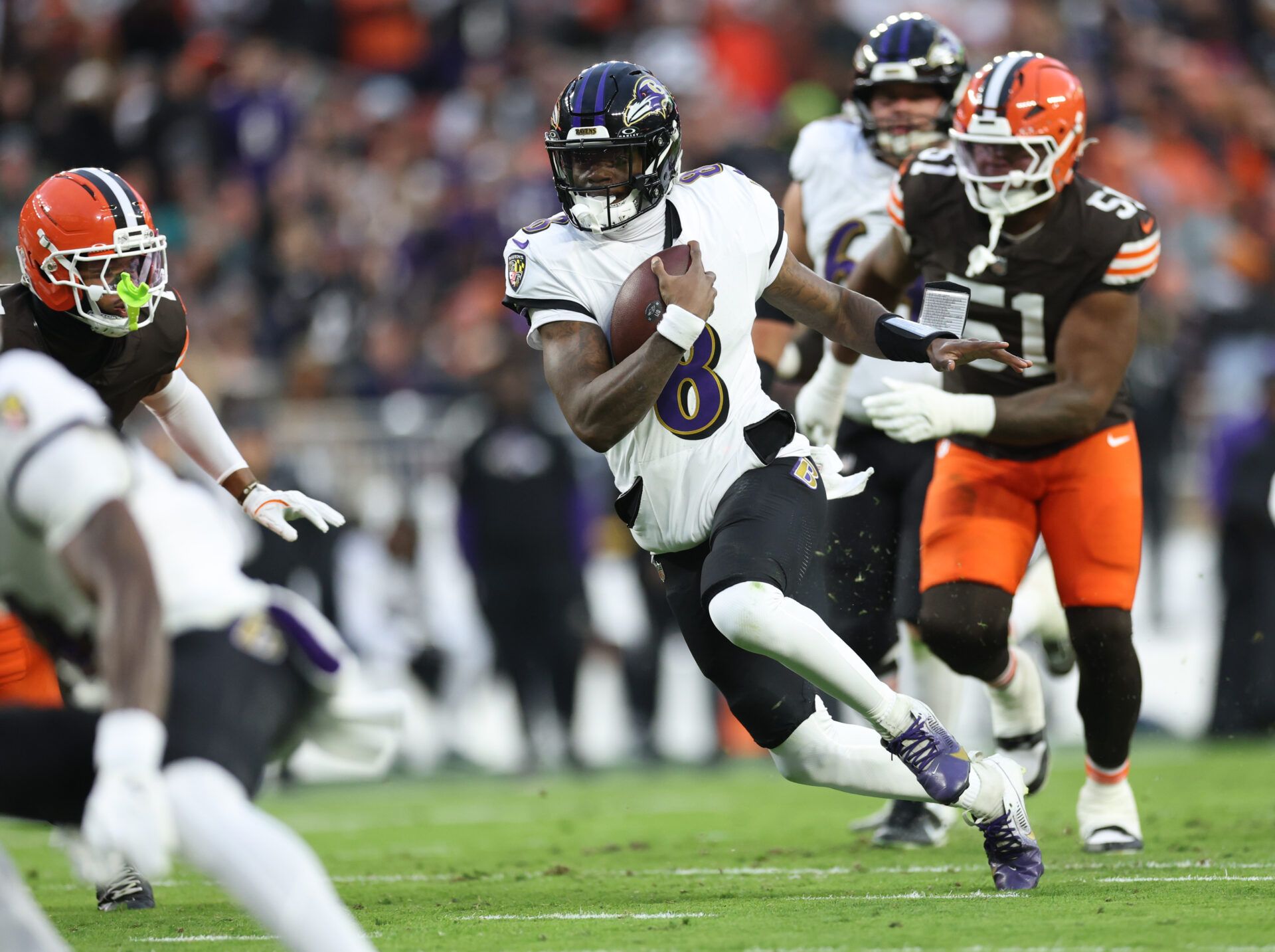 Baltimore Ravens quarterback Lamar Jackson (8) runs for a gain during the first quarter against the Cleveland Browns at Huntington Bank Field.