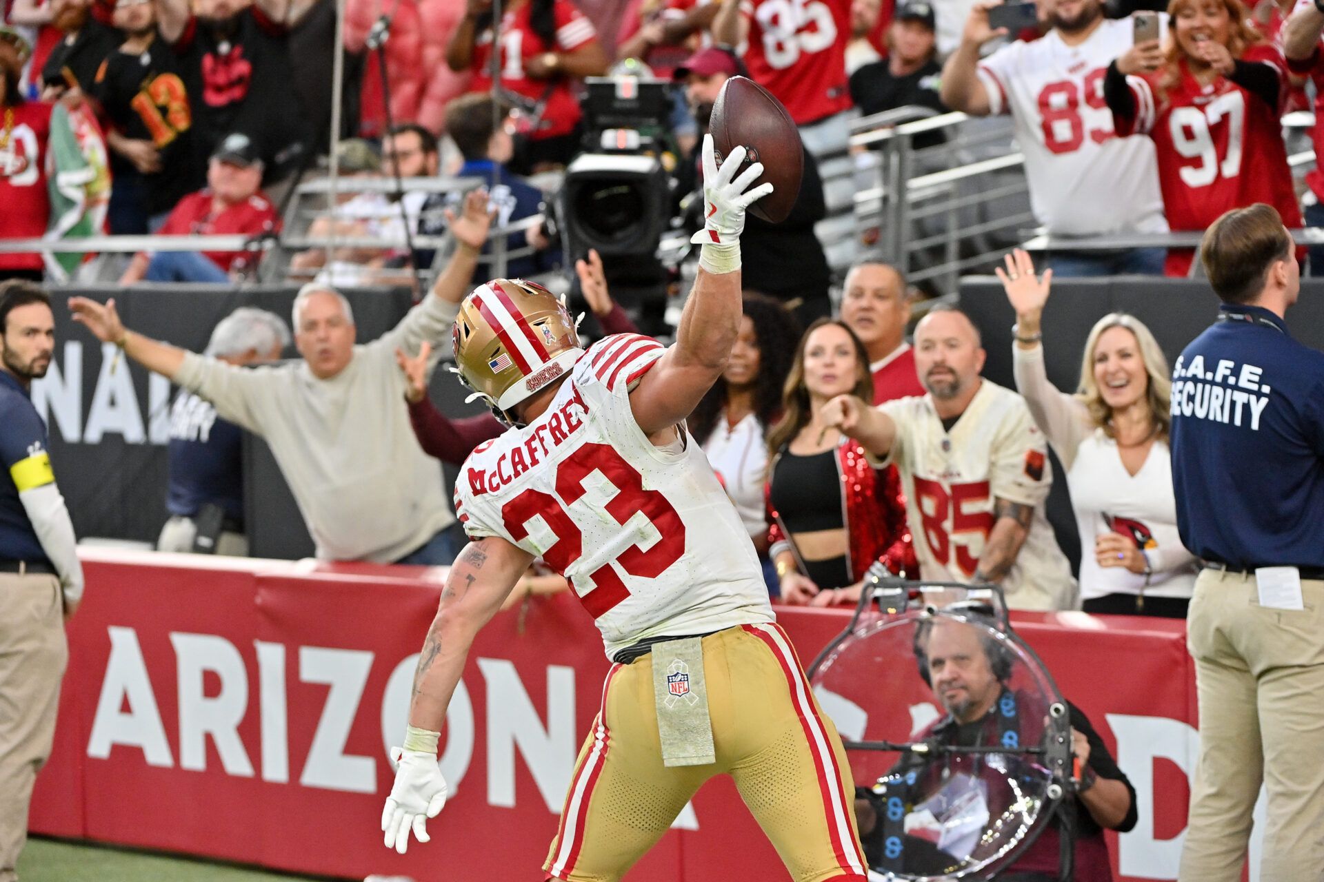 San Francisco 49ers running back Christian McCaffrey (23) celebrates scoring a touchdown in the second half against the Arizona Cardinals at State Farm Stadium.