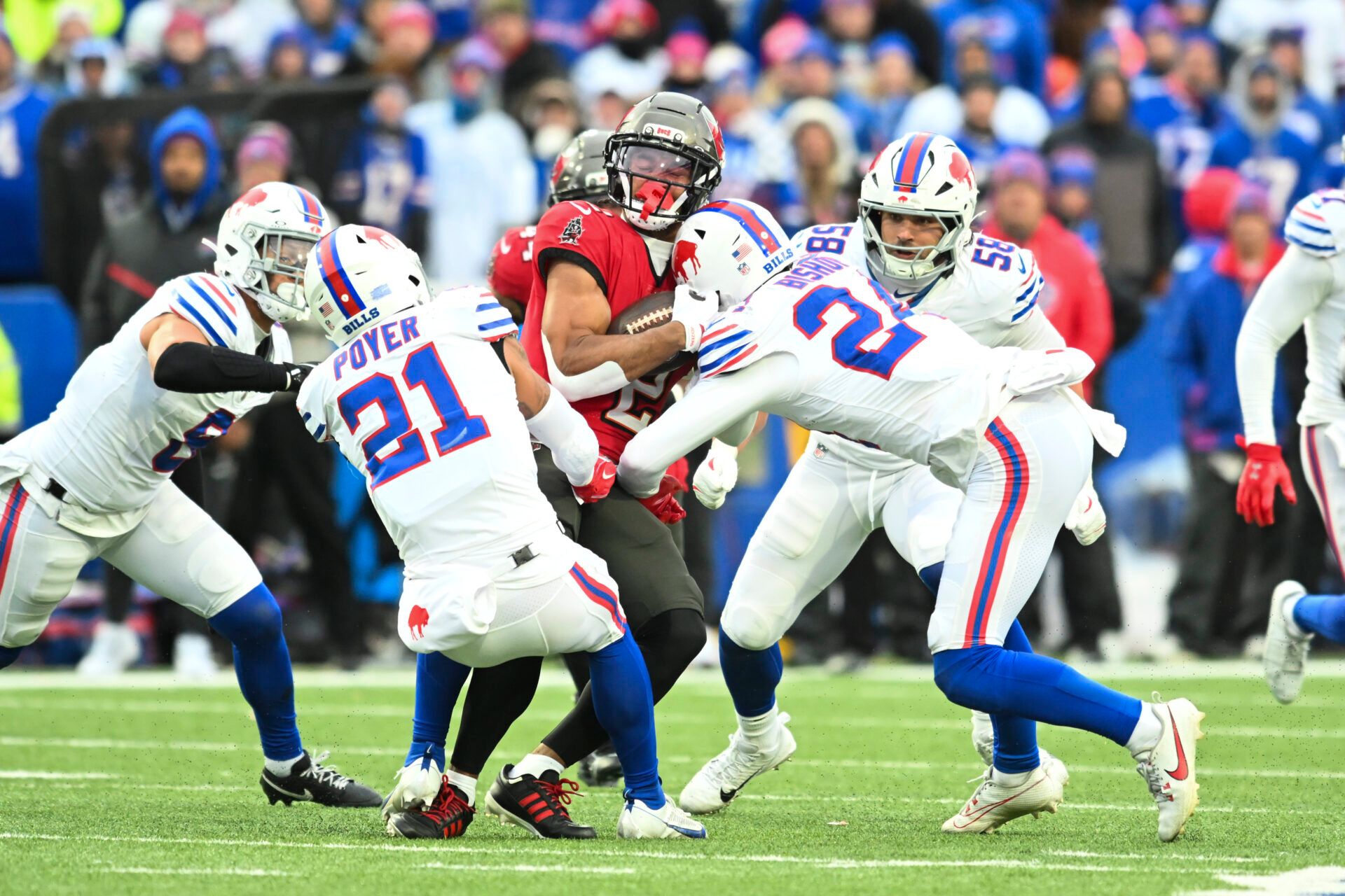Tampa Bay Buccaneers wide receiver Emeka Egbuka (2) takes a hit from Buffalo Bills safety Cole Bishop (24) during the second half of the game at Highmark Stadium.