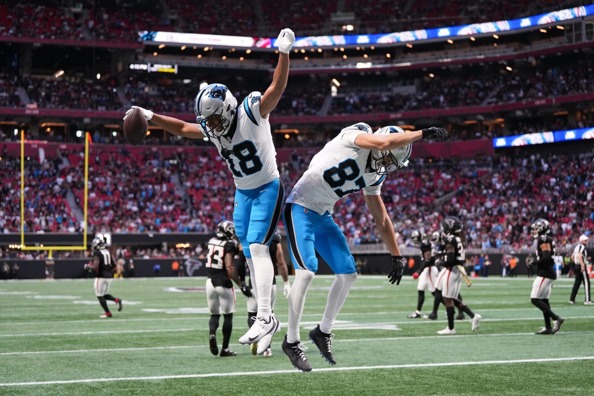 Carolina Panthers wide receiver Jalen Coker (18) celebrates a two point conversion in the fourth quarter against the Atlanta Falcons at Mercedes-Benz Stadium.