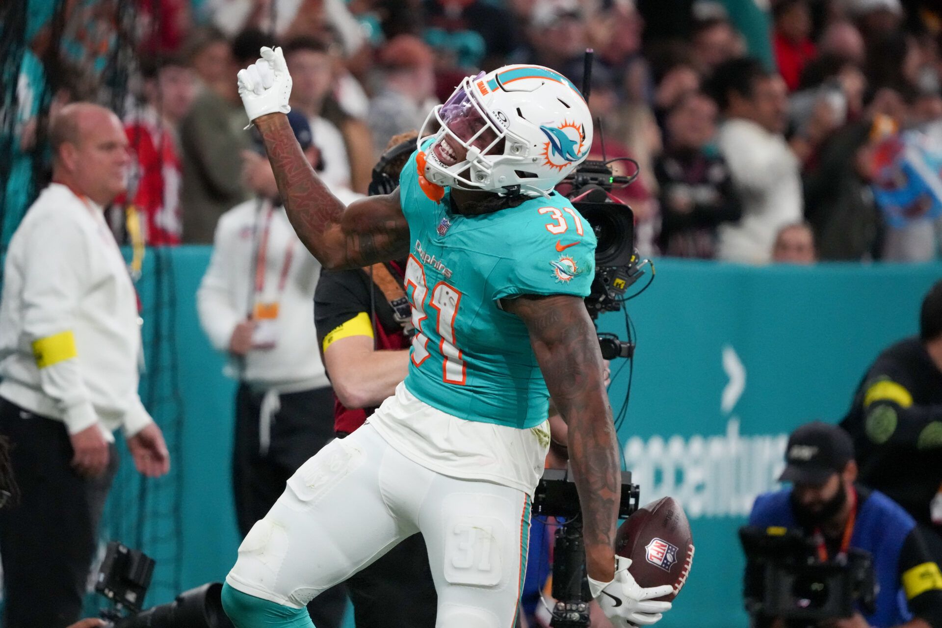 Miami Dolphins running back Ollie Gordon II (31) celebrates after scoring a touchdown against the Washington Commanders in the fourth quarter during the 2025 NFL Madrid Game at Santiago Bernabeu Stadium.