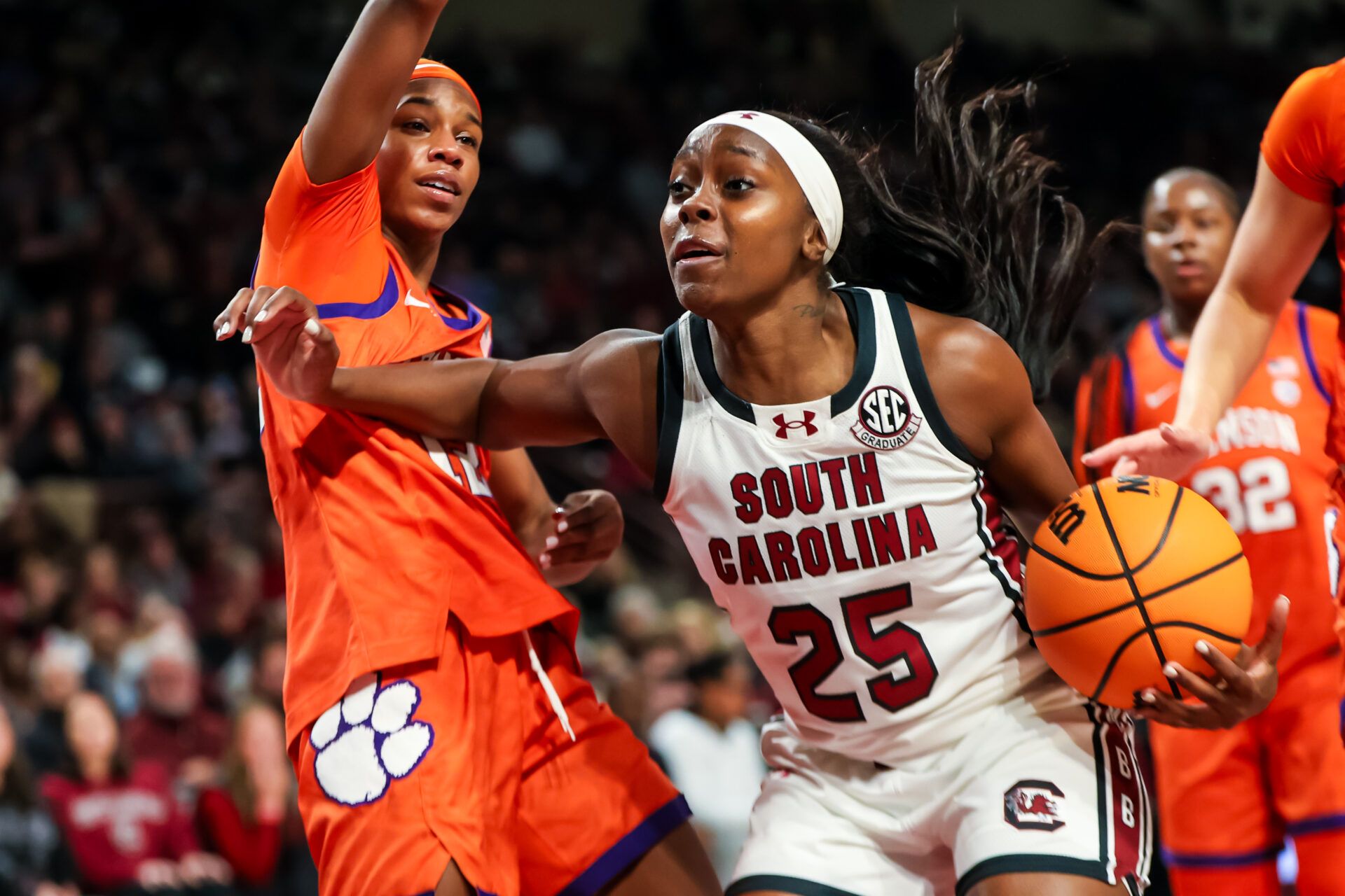 South Carolina Gamecocks guard Raven Johnson (25) attempts to get around Clemson Tigers guard Mia Moore (12) in the first half at Colonial Life Arena.