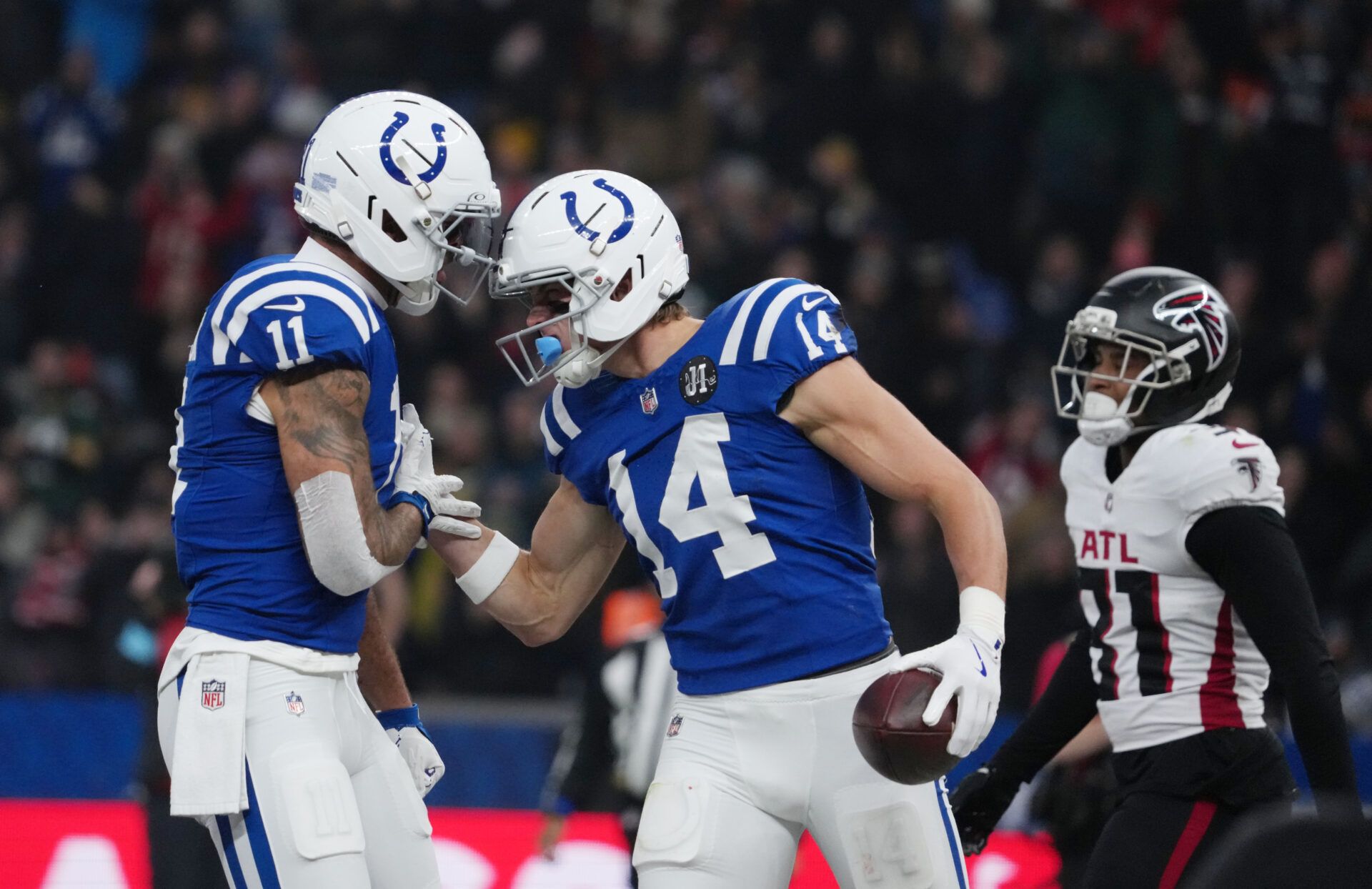 Indianapolis Colts wide receiver Alec Pierce (14) and Indianapolis Colts wide receiver Michael Pittman Jr. (11) react against the Atlanta Falcons during the NFL Berlin Game at Olympic Stadium.
