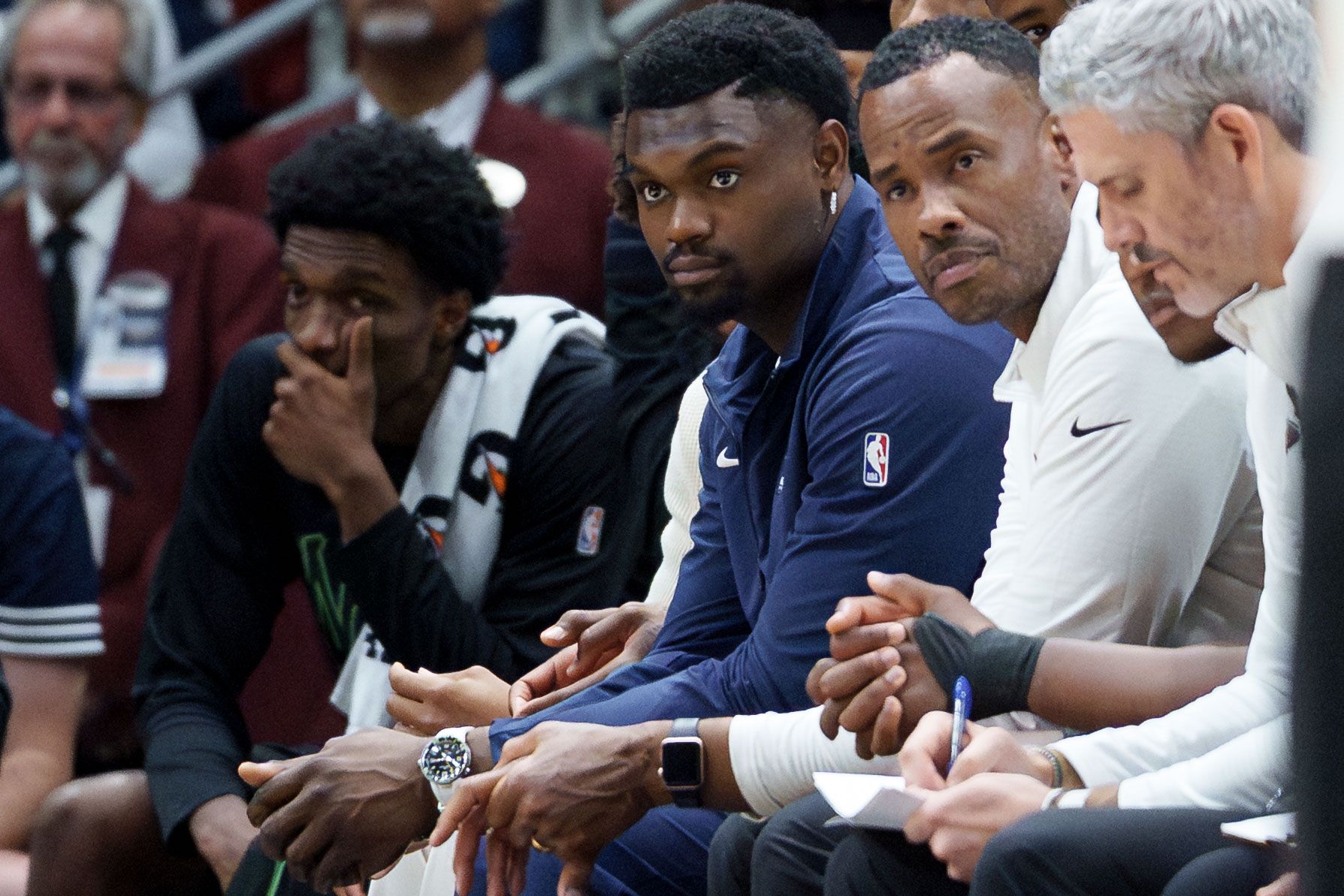 New Orleans Pelicans forward Zion Williamson, center, looks from the bench against the Golden State Warriors during the second half at Smoothie King Center.