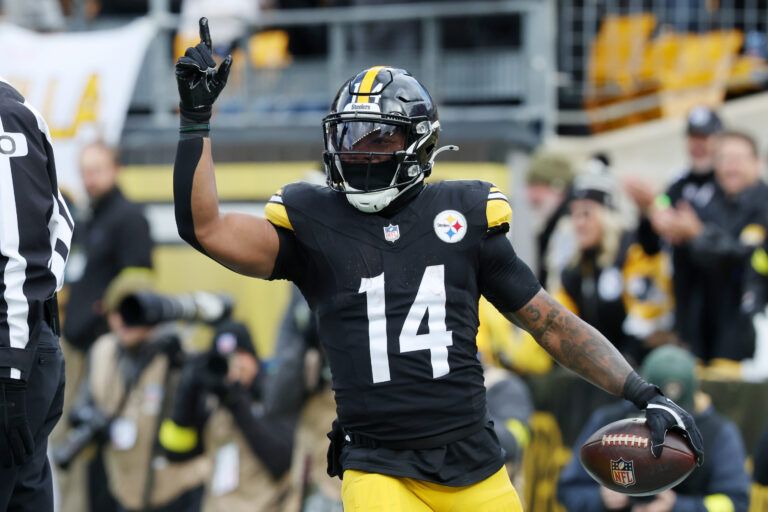 Pittsburgh Steelers running back Kenneth Gainwell (14) reacts after scoring a touchdown against the Cincinnati Bengals during the first half at Acrisure Stadium.