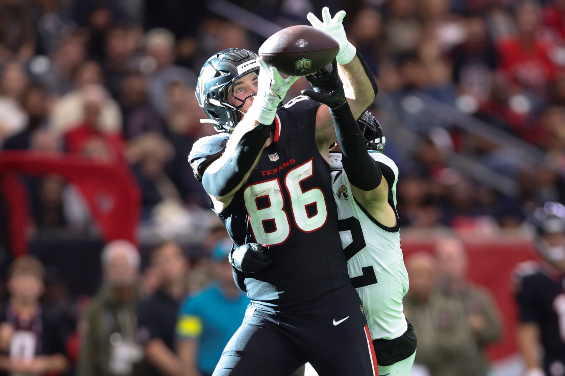 Houston Texans tight end Dalton Schultz (86) attempts to make a recption as Jacksonville Jaguars safety Andrew Wingard (42) defends during the fourth quarter at NRG Stadium.