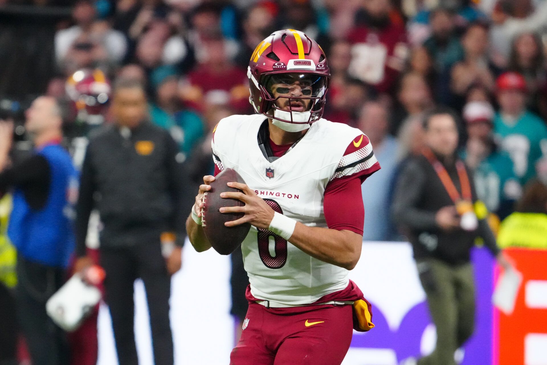 Washington Commanders quarterback Marcus Mariota (8) looks to pass the ball against the Miami Dolphins in the first quarter during the 2025 NFL Madrid Game at Santiago Bernabeu Stadium.
