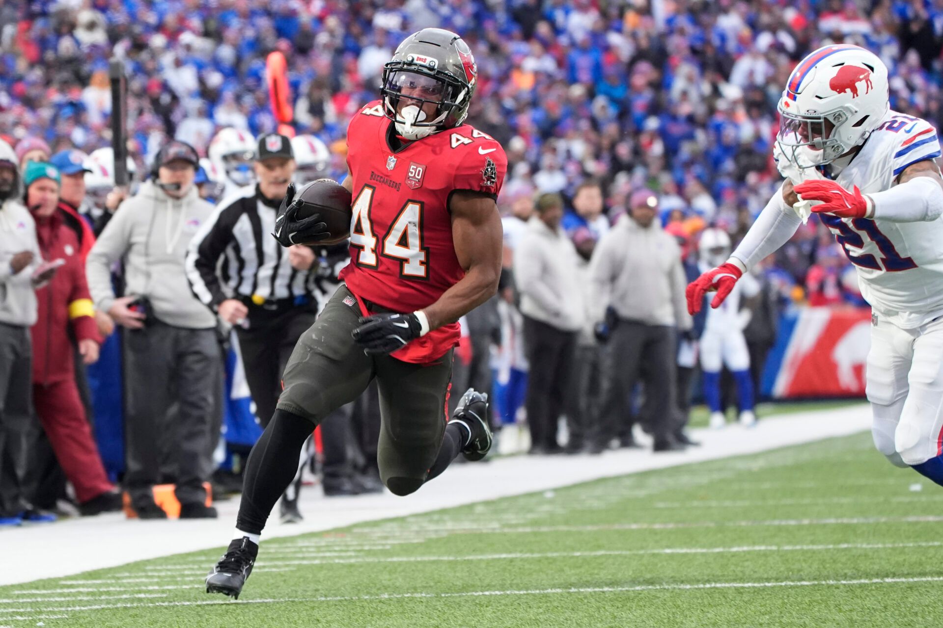 Tampa Bay Buccaneers running back Sean Tucker (44) runs the ball for a touchdown against Buffalo Bills safety Jordan Poyer (21) during the second half of the game at Highmark Stadium.