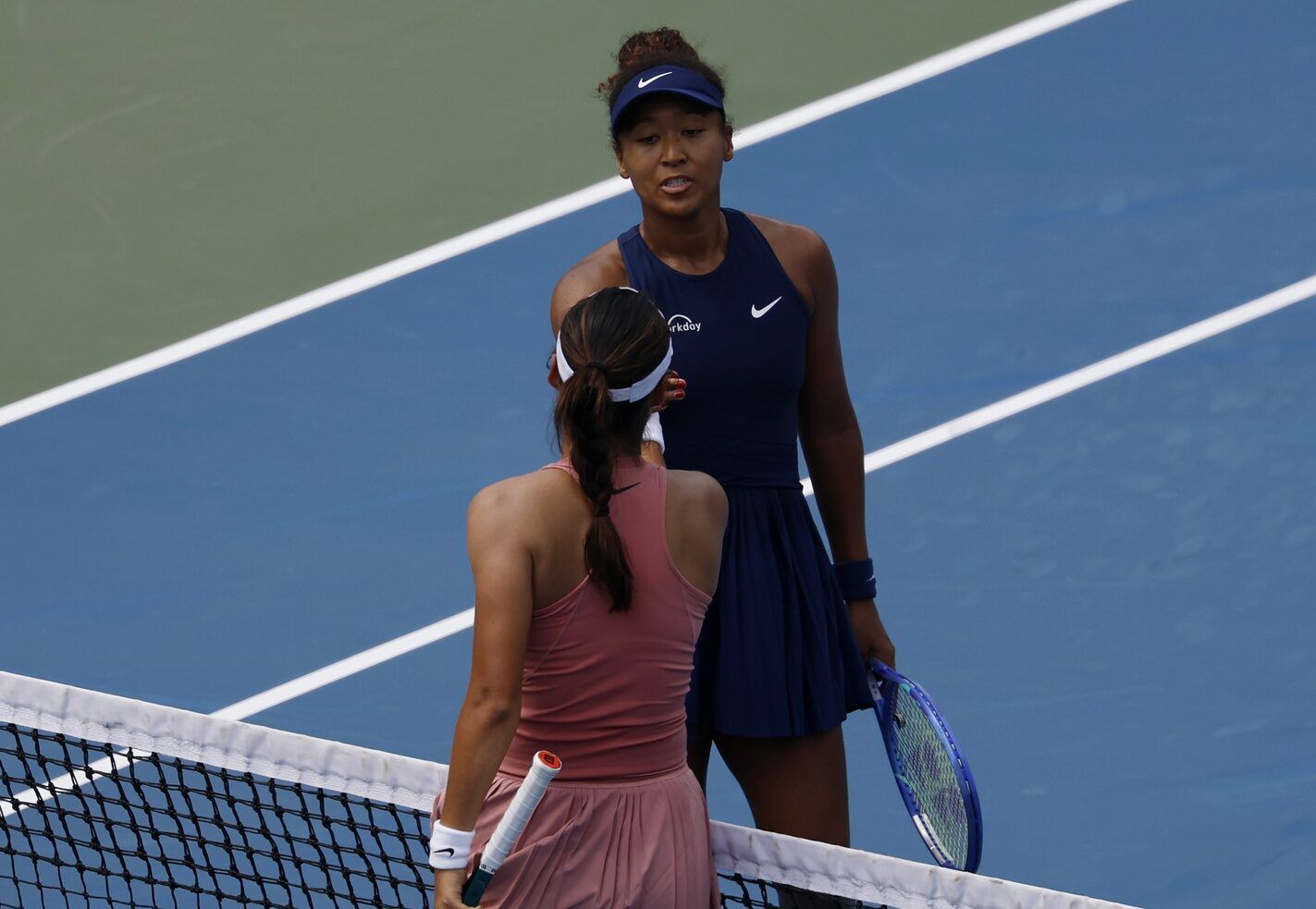 Emma Raducanu (GBR)(bottom) shakes hands with Naomi Osaka (JPN)(top) at the net after their women's singles match on day four of the Mubadala Citi DC Open at Rock Creek Park Tennis Center.