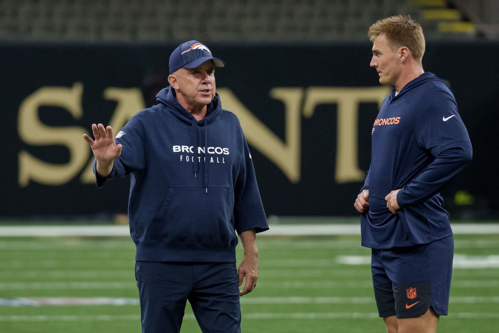 Denver Broncos head coach Sean Payton talks to Denver Broncos quarterback Bo Nix (10) before a game against the New Orleans Saints at Caesars Superdome.