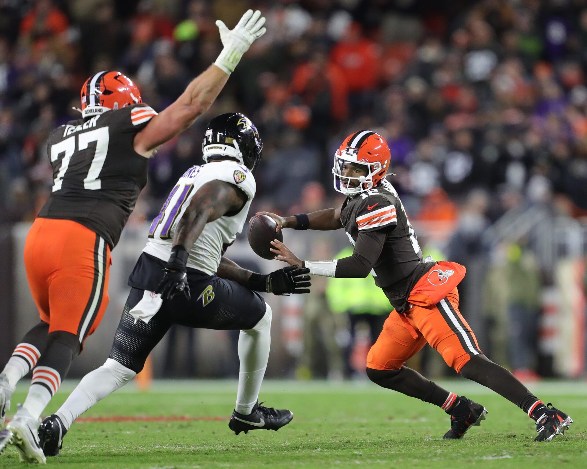Cleveland Browns quarterback Shedeur Sanders (12) tries to get away from Baltimore Ravens defensive end Dre'Mont Jones (41) during the second half of an NFL football game at Huntington Bank Field, Nov. 16, 2025, in Cleveland, Ohio.