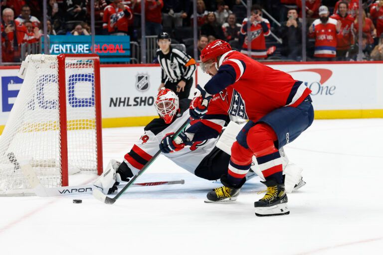New Jersey Devils goaltender Jake Allen (34) makes a save against on Washington Capitals left wing Alex Ovechkin (8) in a shootout at Capital One Arena.