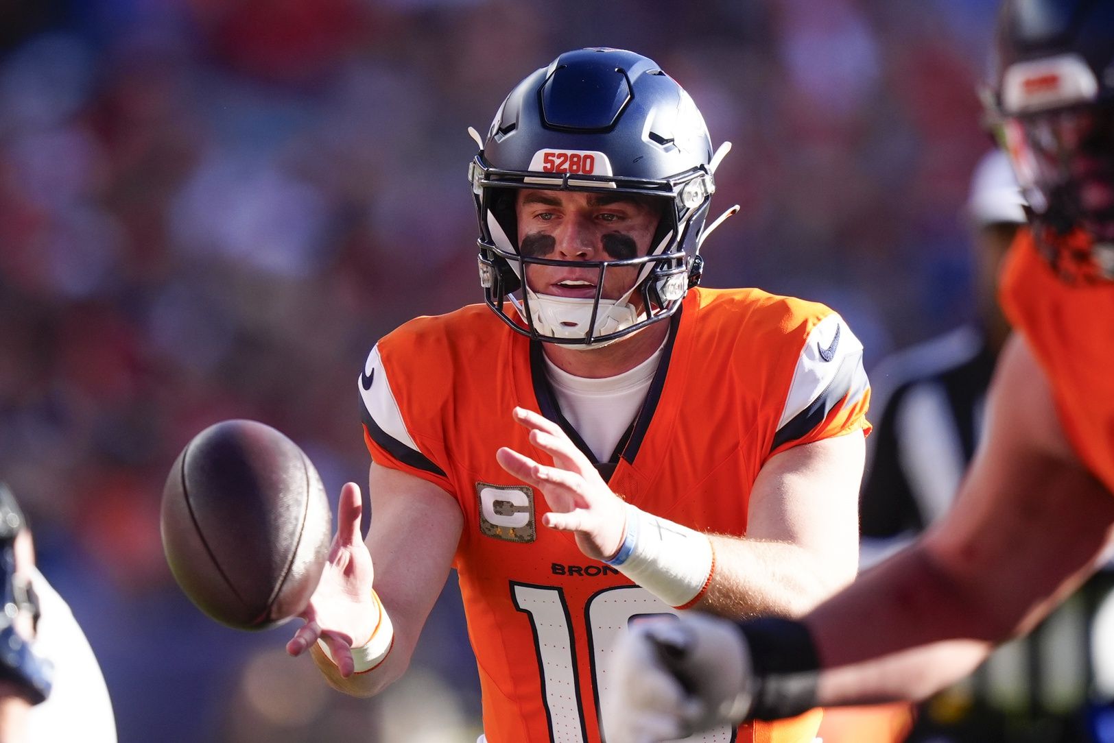 Denver Broncos quarterback Bo Nix (10) takes the snap during the first quarter of the game against the Kansas City Chiefs at Empower Field at Mile High.