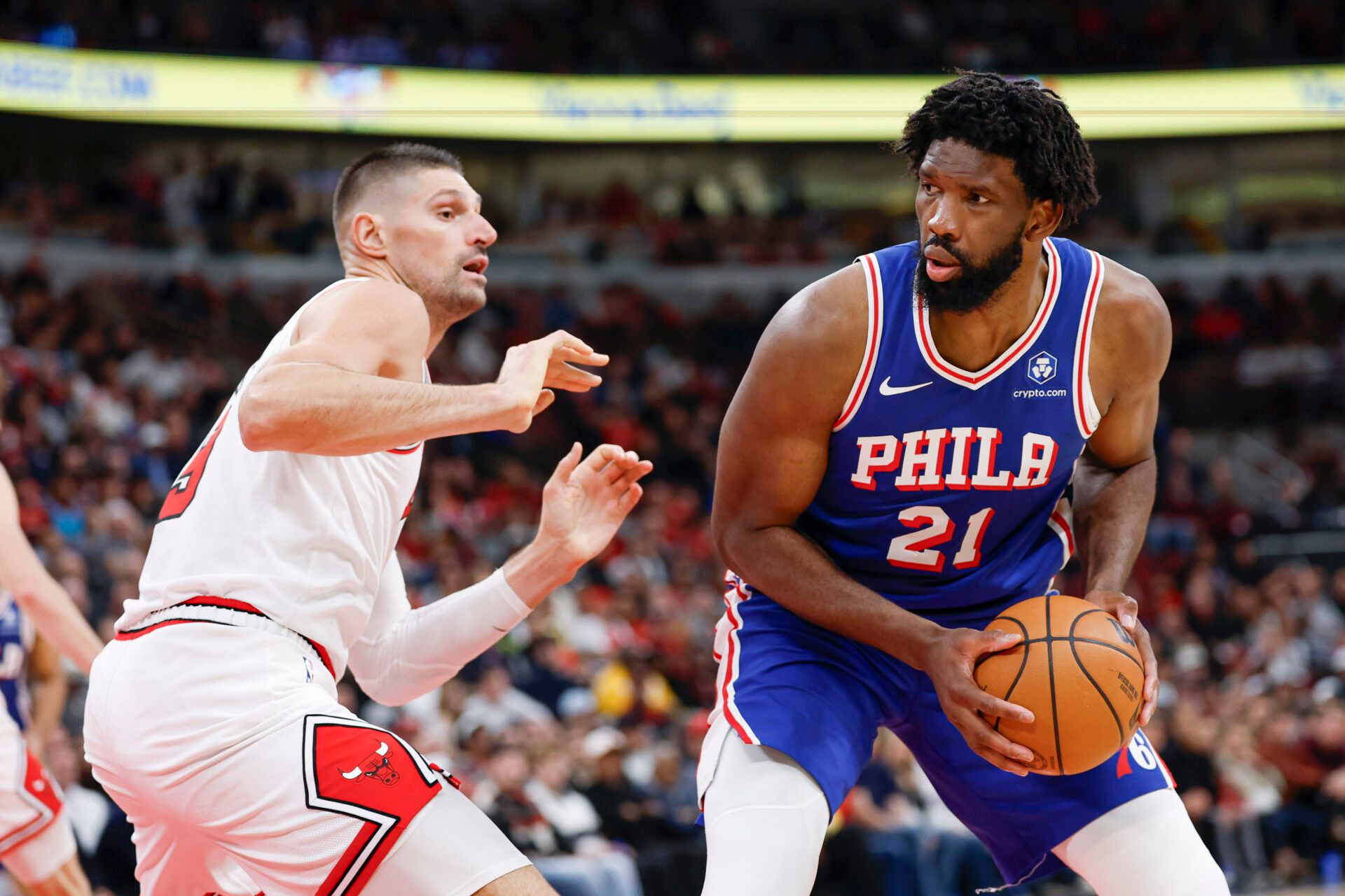 Chicago Bulls center Nikola Vucevic (9) defends against Philadelphia 76ers center Joel Embiid (21) during the second half at United Center.