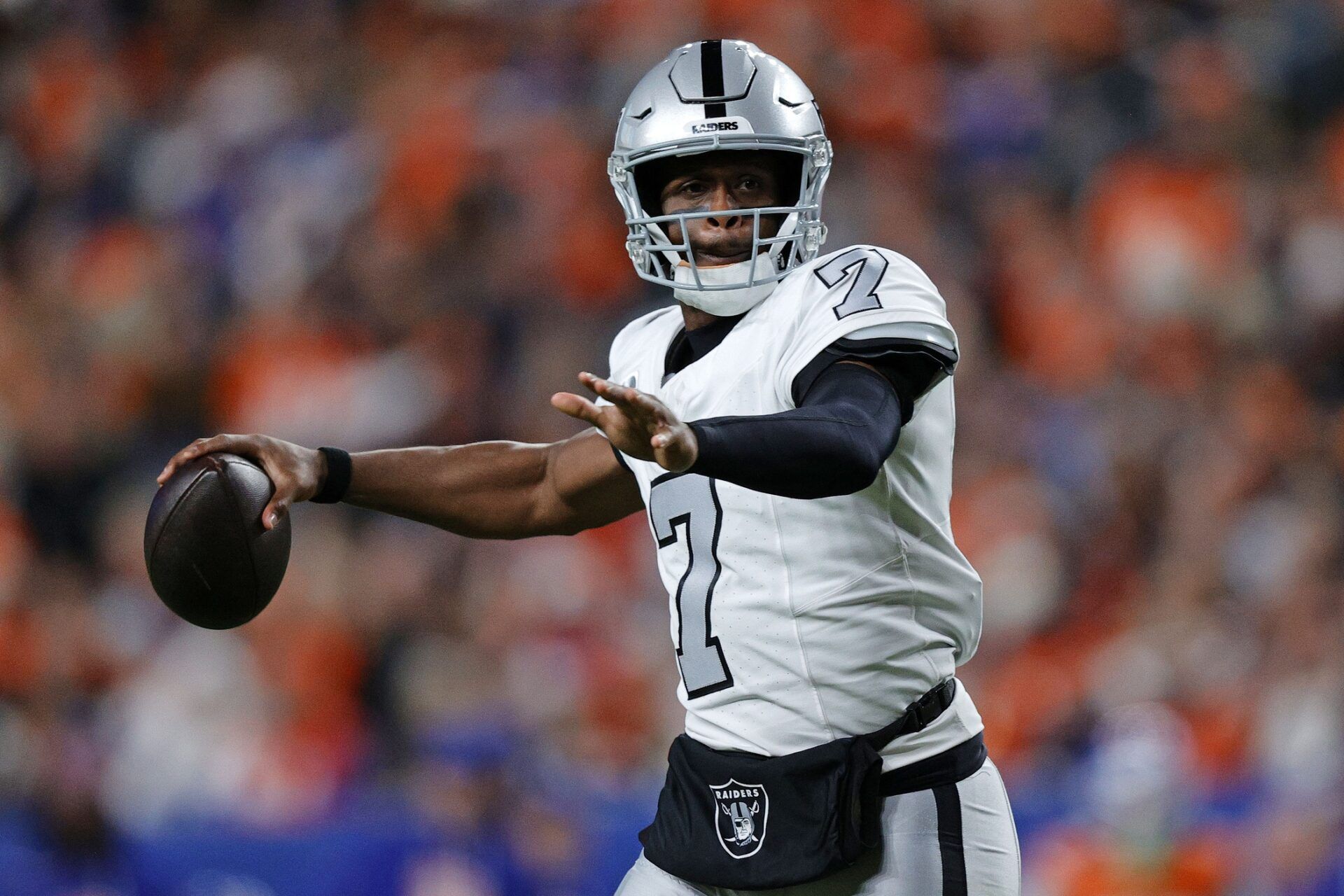 Las Vegas Raiders quarterback Geno Smith (7) drops back to pass against the Denver Broncos during the first half at Empower Field at Mile High.