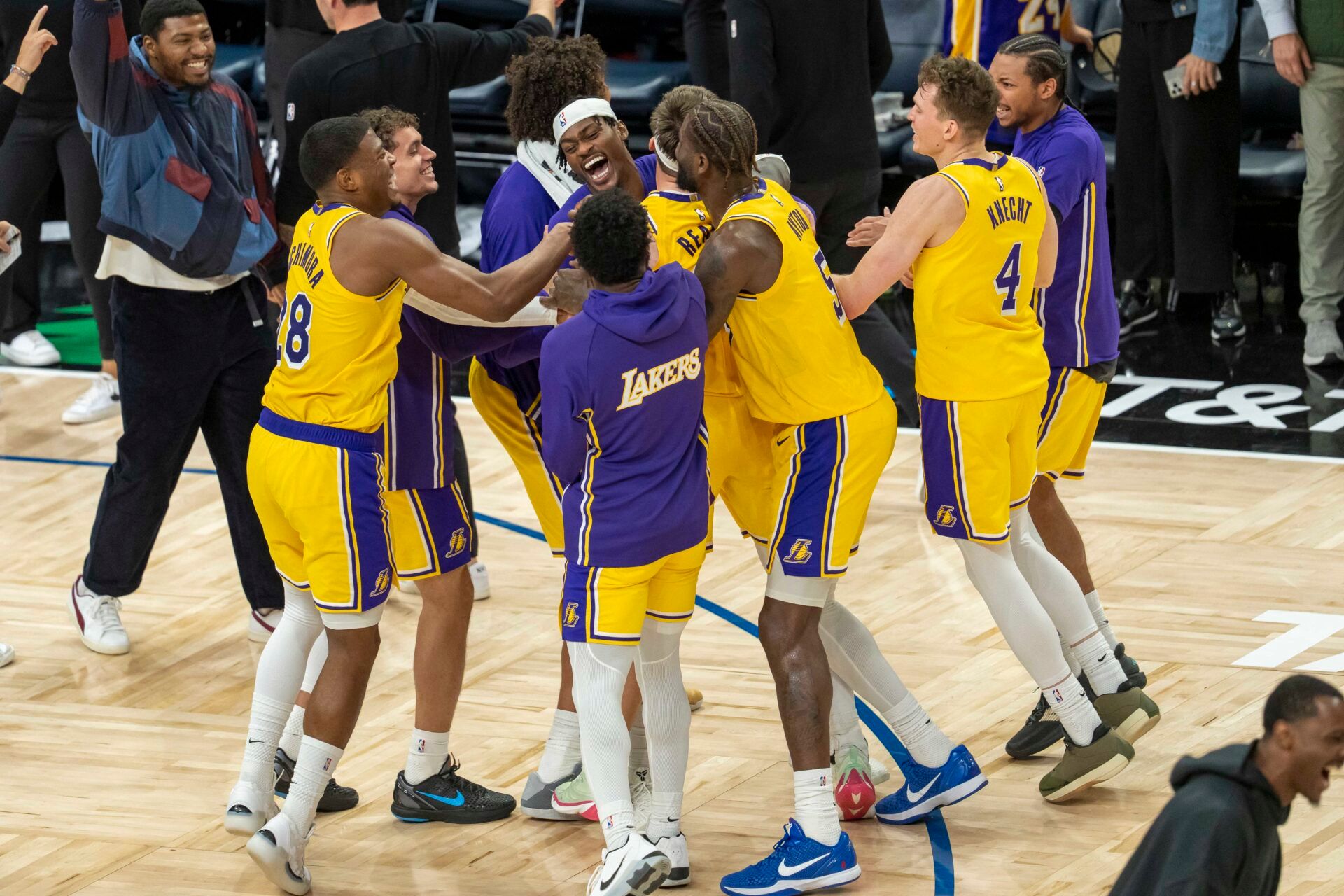 Los Angeles Lakers guard Austin Reaves (15) celebrates with forward Jarred Vanderbilt (2) and center Deandre Ayton (5) after making a buzzer beater shot against the Minnesota Timberwolves at Target Center.