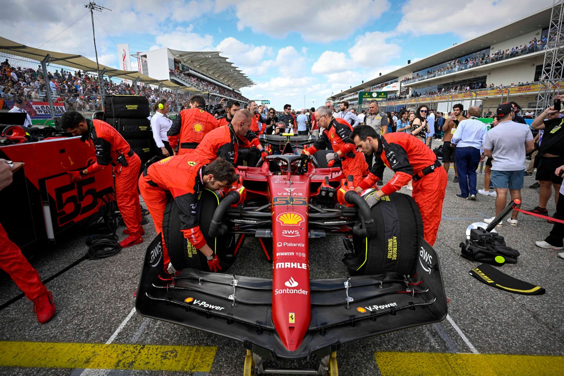 USA; The crew of Scuderia Ferrari driver Carlos Sainz (55) of Team Spain wheel their car onto the grid before the start of the U.S. Grand Prix F1 race at Circuit of the Americas.