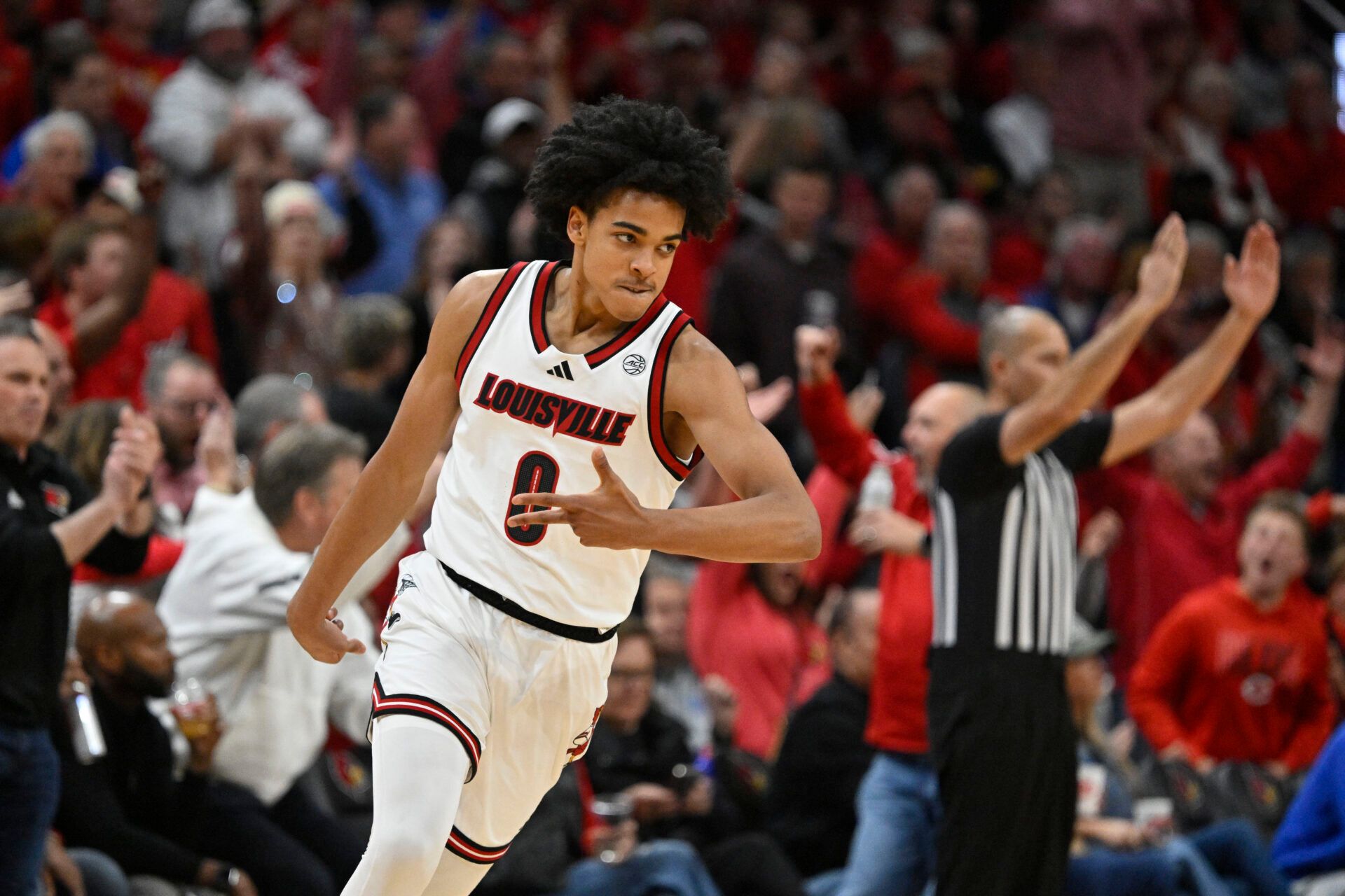 Louisville Cardinals guard Mikel Brown Jr. (0) reacts after making a three pointer against the Kentucky Wildcats during the first half at KFC Yum! Center.