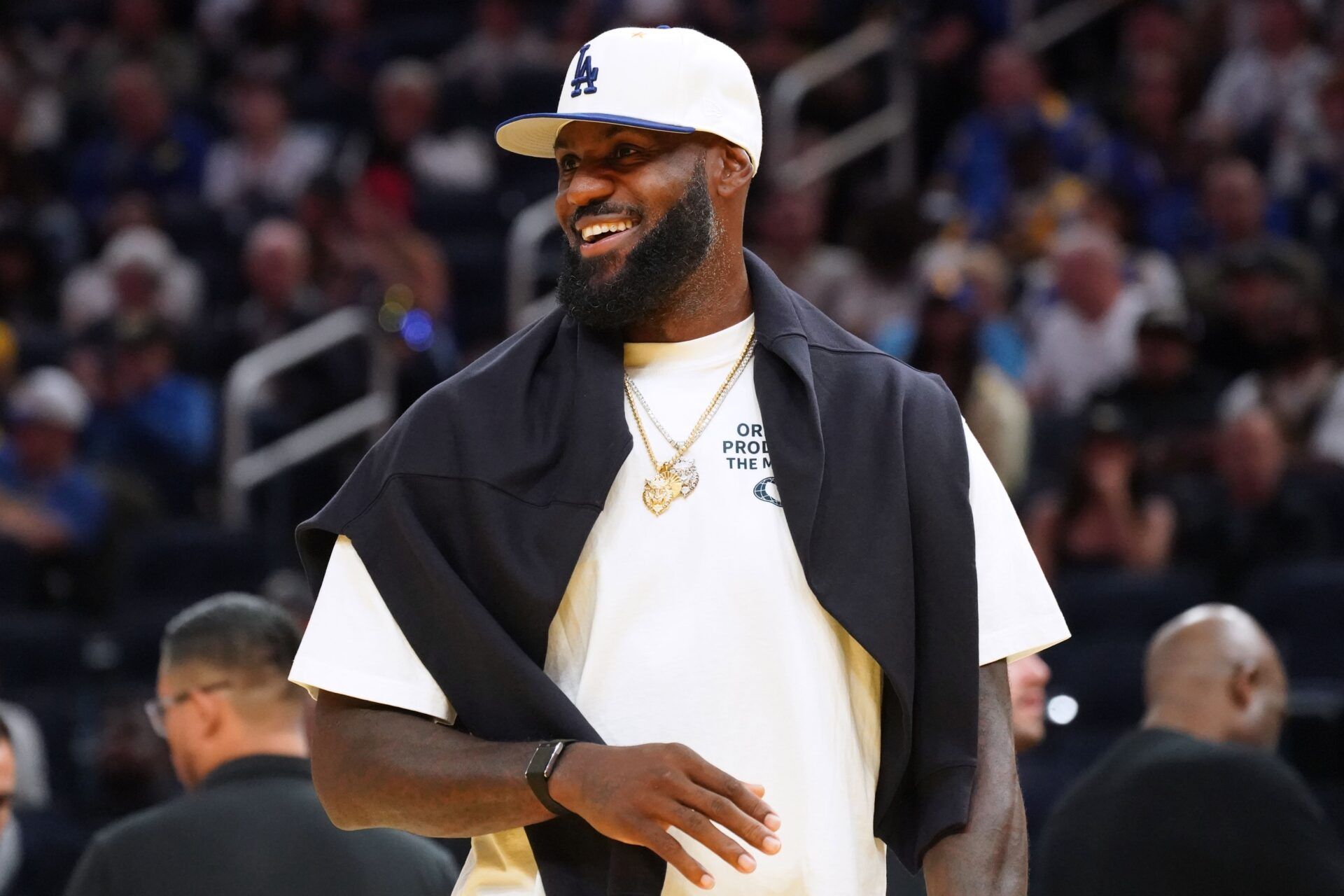 Los Angeles Lakers forward LeBron James (23), wearing a Los Angeles Dodgers hat, watches from the sideline during a break against the Golden State Warriors in the third quarter at Chase Center.