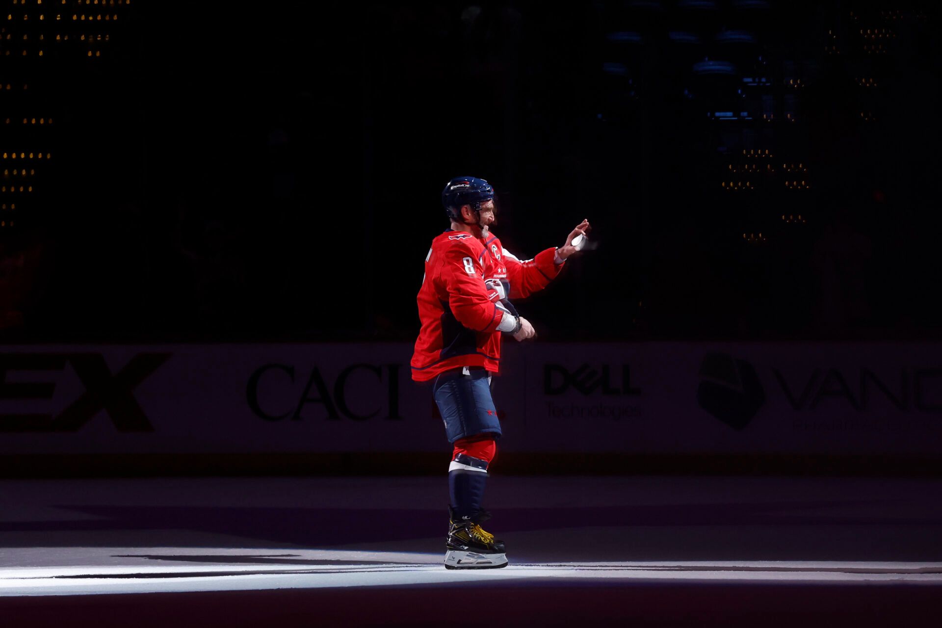 Washington Capitals left wing Alex Ovechkin (8) prepares to toss a puck in the stands after being named number two star of the game against the Los Angeles Kings at Capital One Arena.