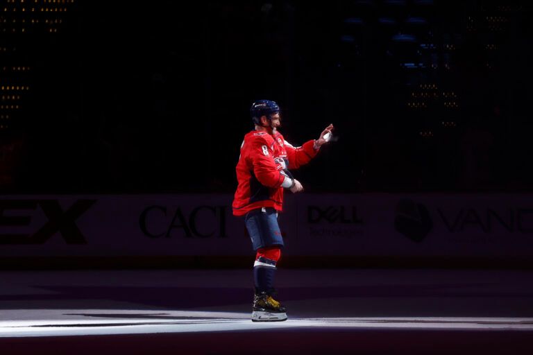 Washington Capitals left wing Alex Ovechkin (8) prepares to toss a puck in the stands after being named number two star of the game against the Los Angeles Kings at Capital One Arena.
