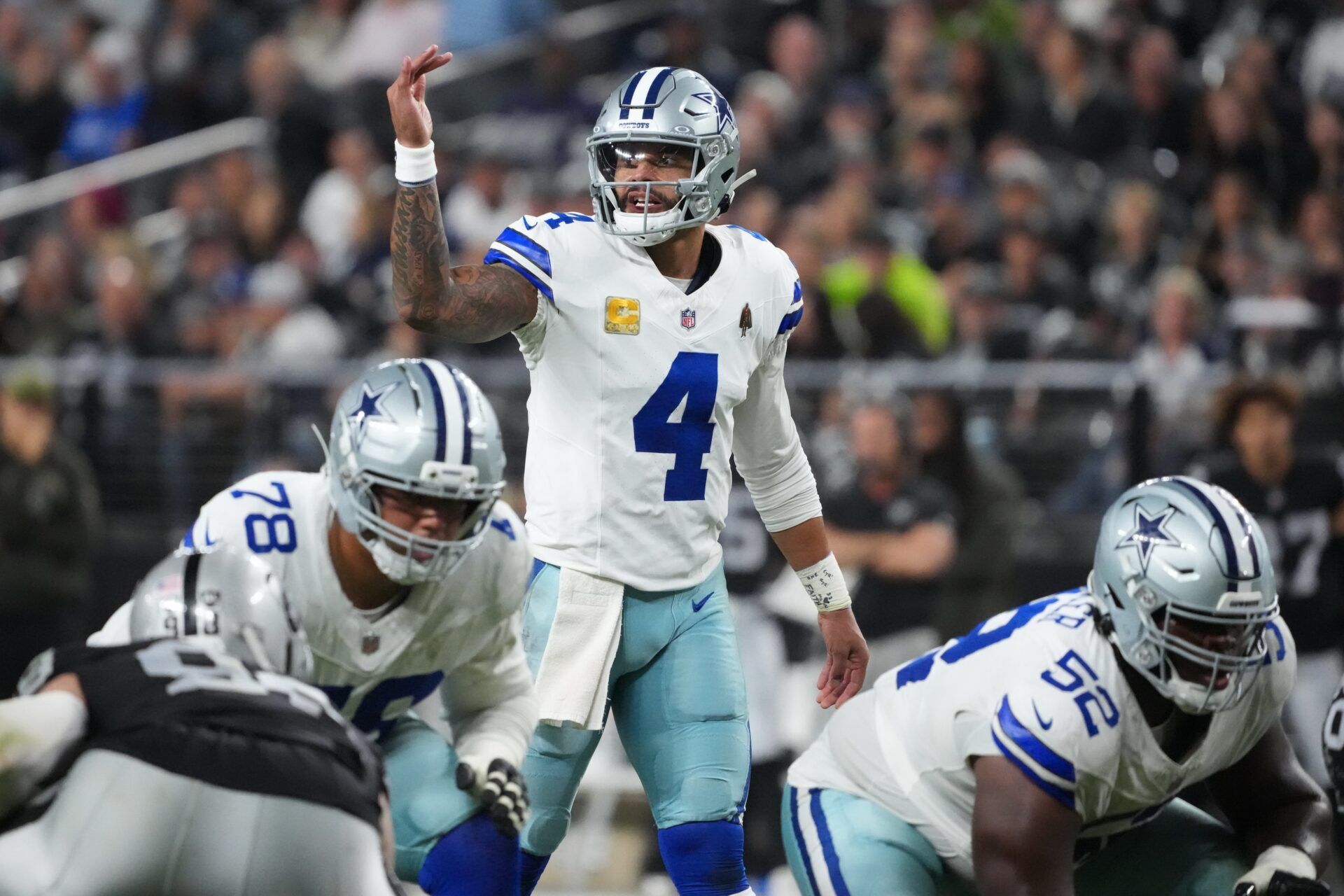 Dallas Cowboys quarterback Dak Prescott (4) gestures at the line of scrimmage against the Las Vegas Raiders during the second half at Allegiant Stadium.