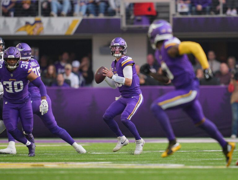 Minnesota Vikings quarterback J.J. McCarthy (9) looks to throw downfield during the first quarter against the Chicago Bears at U.S. Bank Stadium.