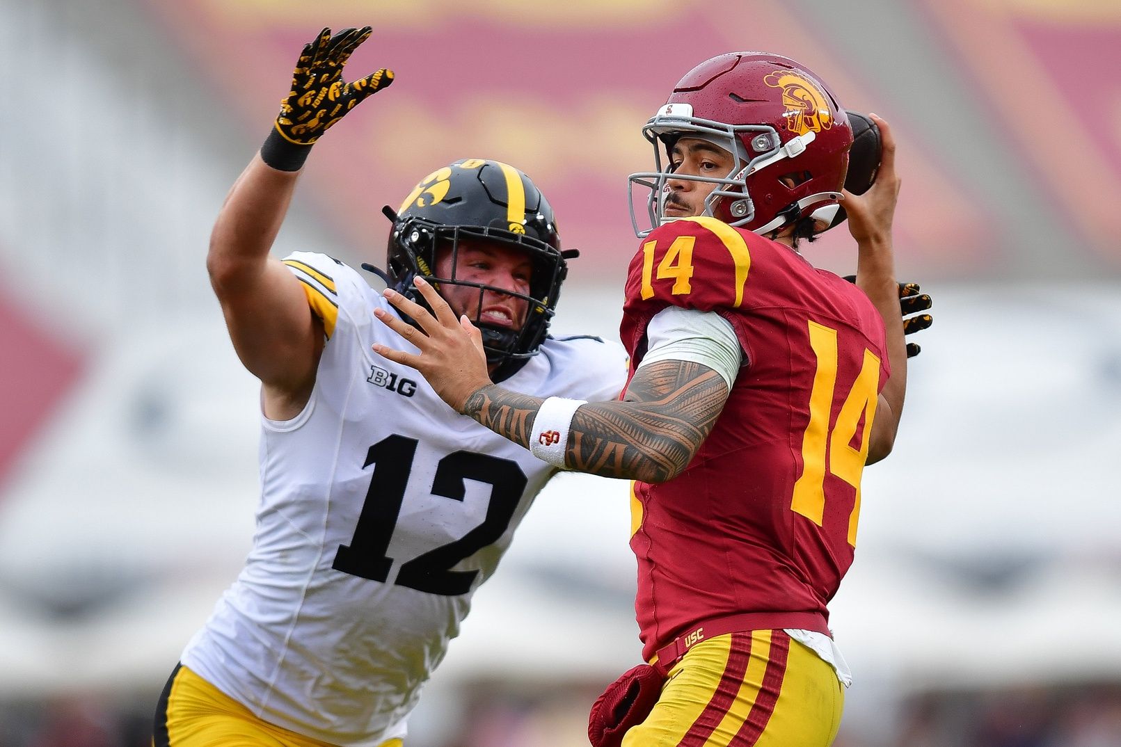 Iowa Hawkeyes defensive back Jaxon Rexroth (12) moves in against Southern California Trojans quarterback Jayden Maiava (14) during the second half at the Los Angeles Memorial Coliseum.