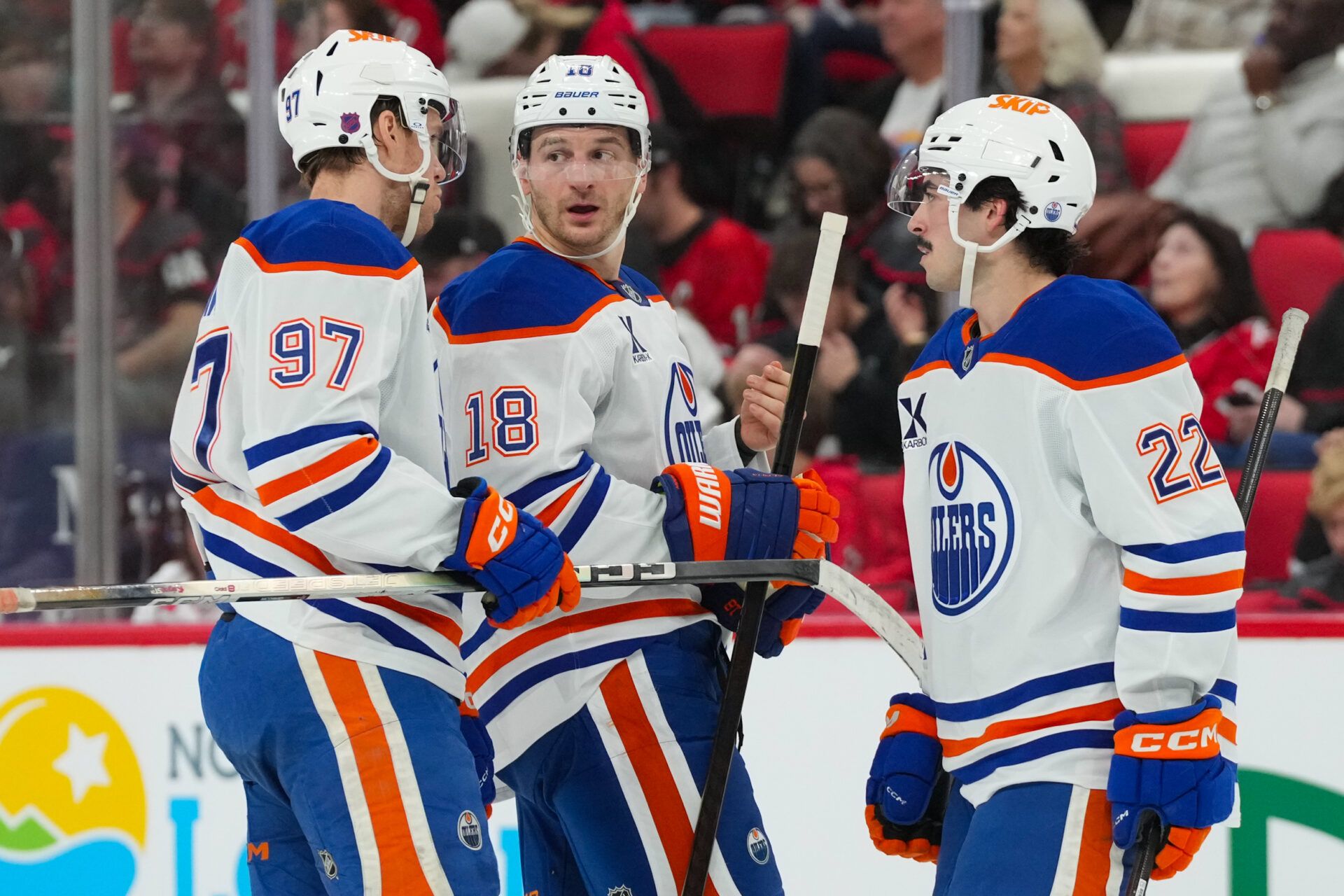 Edmonton Oilers center Connor McDavid (97) left wing Zach Hyman (18) and center Matt Savoie (22) talk Carolina Hurricanes during the second period at Lenovo Center.