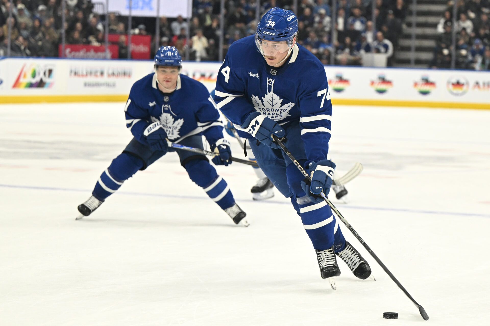 Toronto Maple Leafs forward Bobby McMann (74) skates with the puck ahead of forward Max Domi (11) against the St. Louis Blues in the third period at Scotiabank Arena.