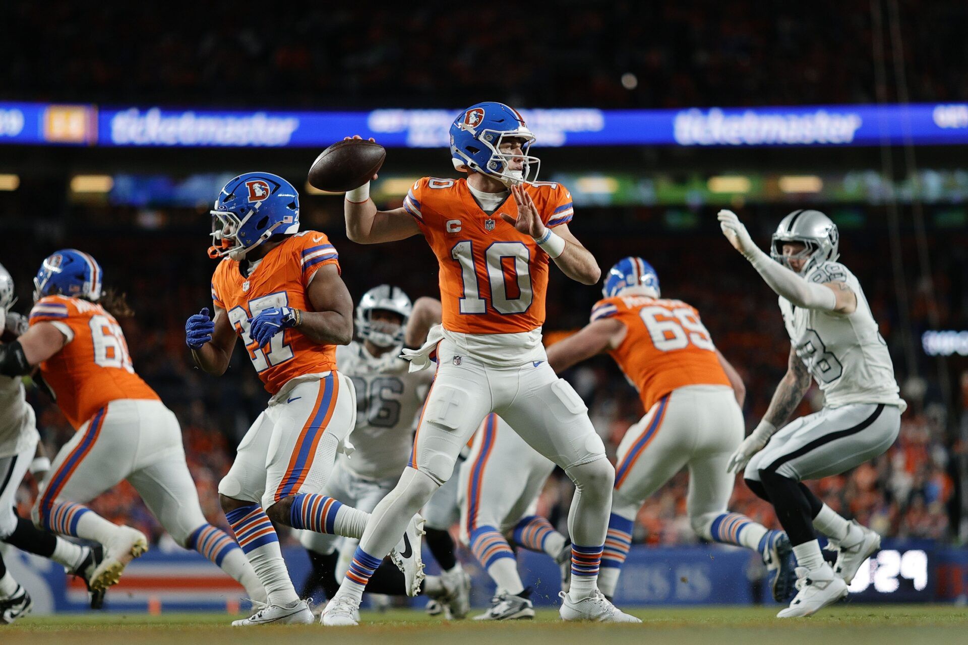 Denver Broncos quarterback Bo Nix (10) drops back to pass against the Las Vegas Raiders during the first half at Empower Field at Mile High.